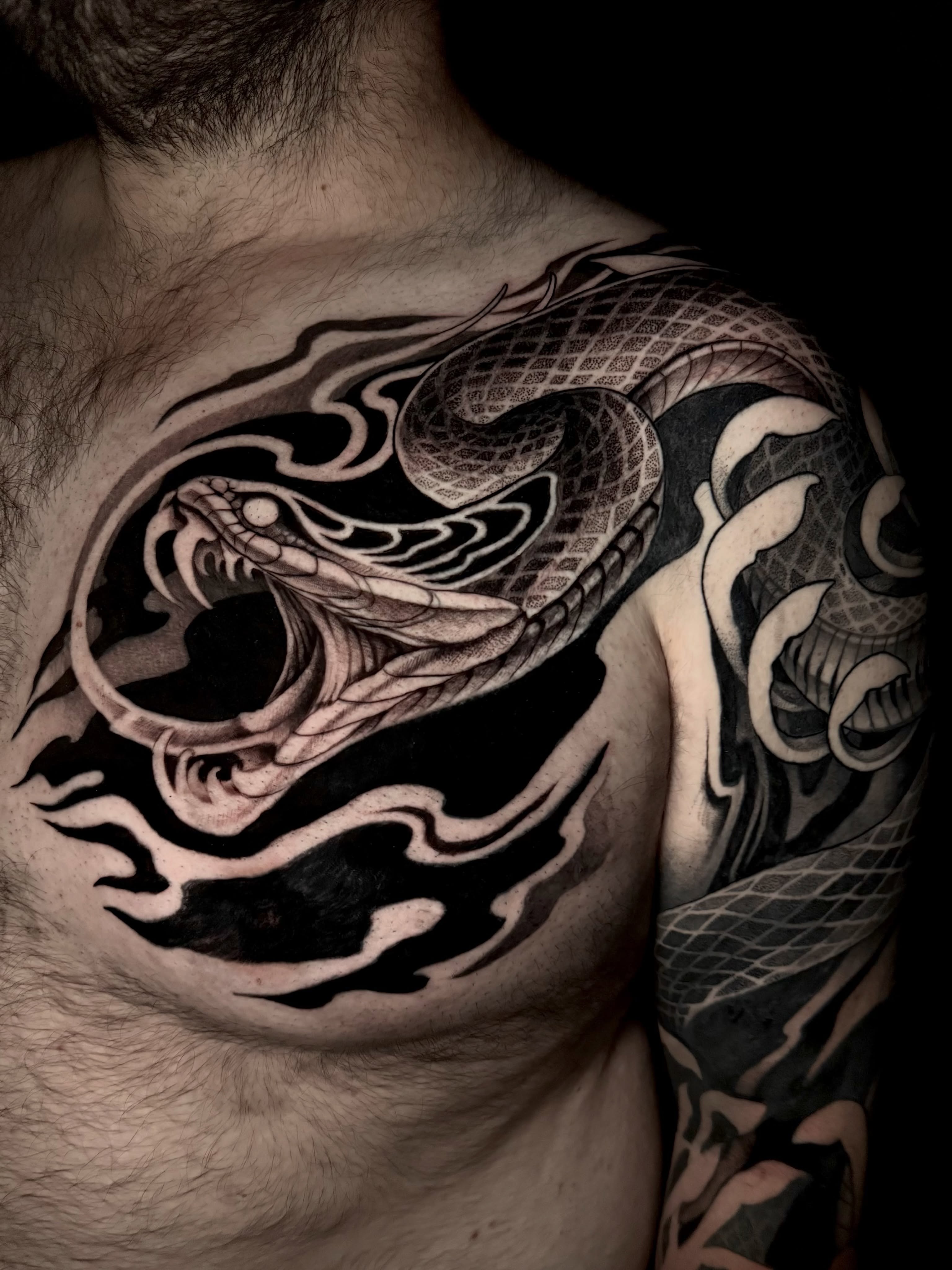 Snake realism tattoo on the chest by Michelle Carlton