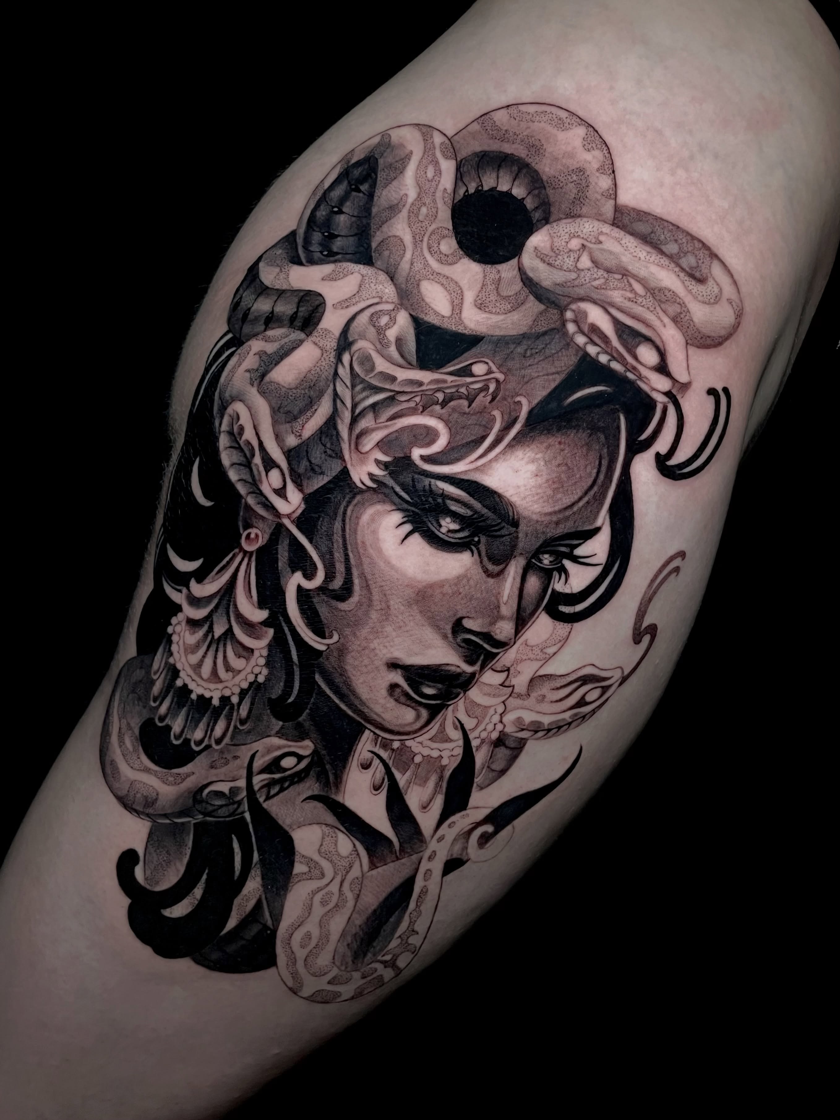Woman with snakes American traditional tattoo on the forearm by Michelle Carlton