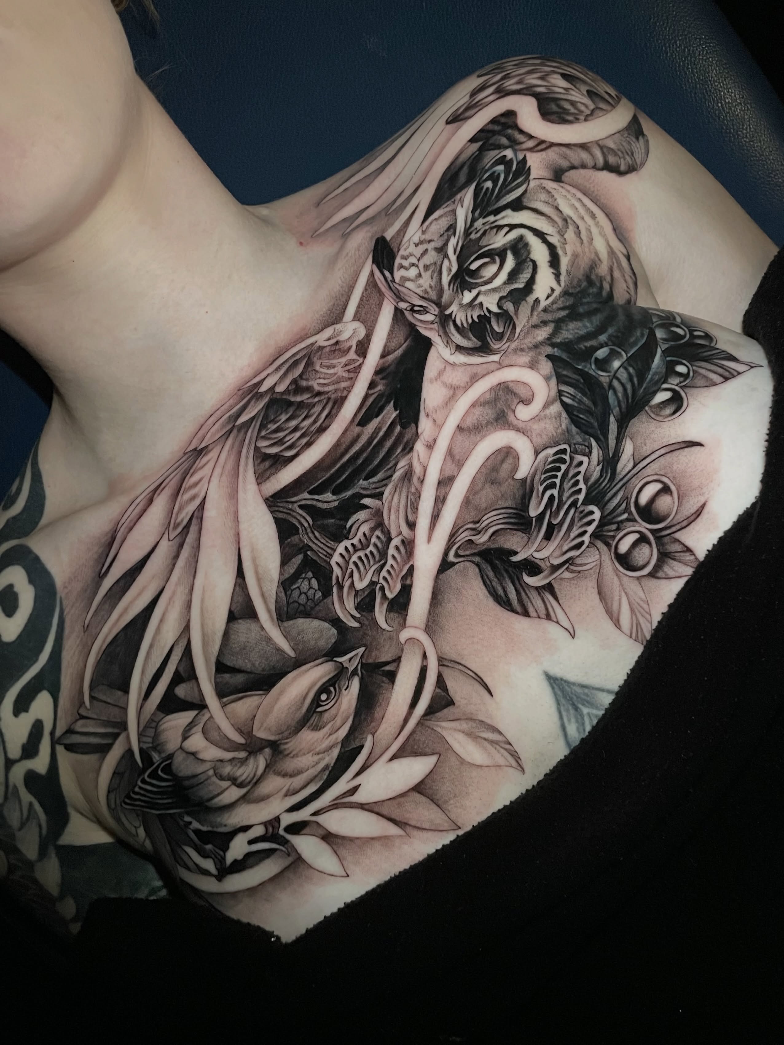 Tiger and bird realism tattoo on the shoulder by Michelle Carlton