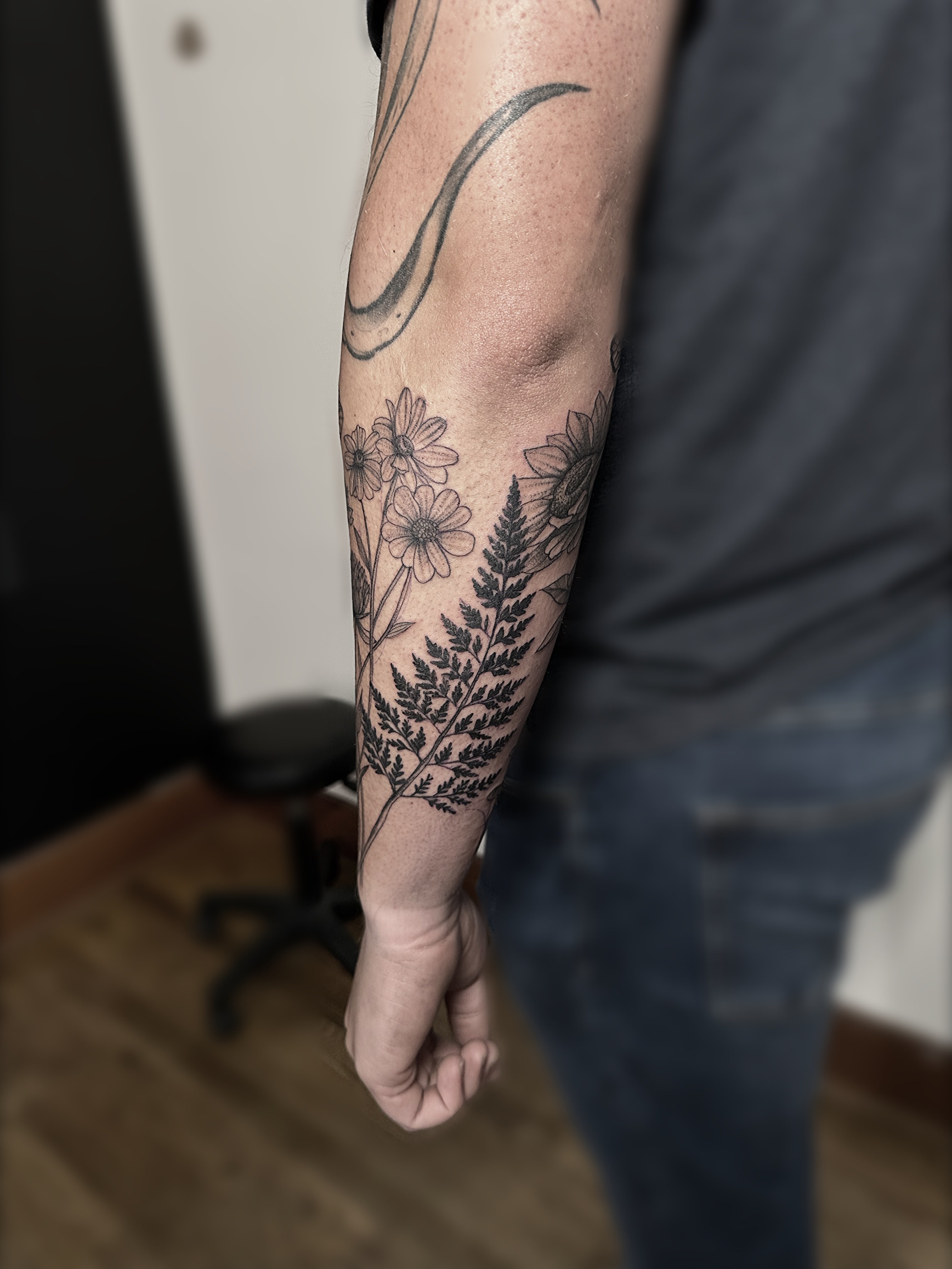 Fern and flowers black and grey tattoo on the forearm by Rafael Alfredo Armas Hoyos, Salt Lake City, Utah