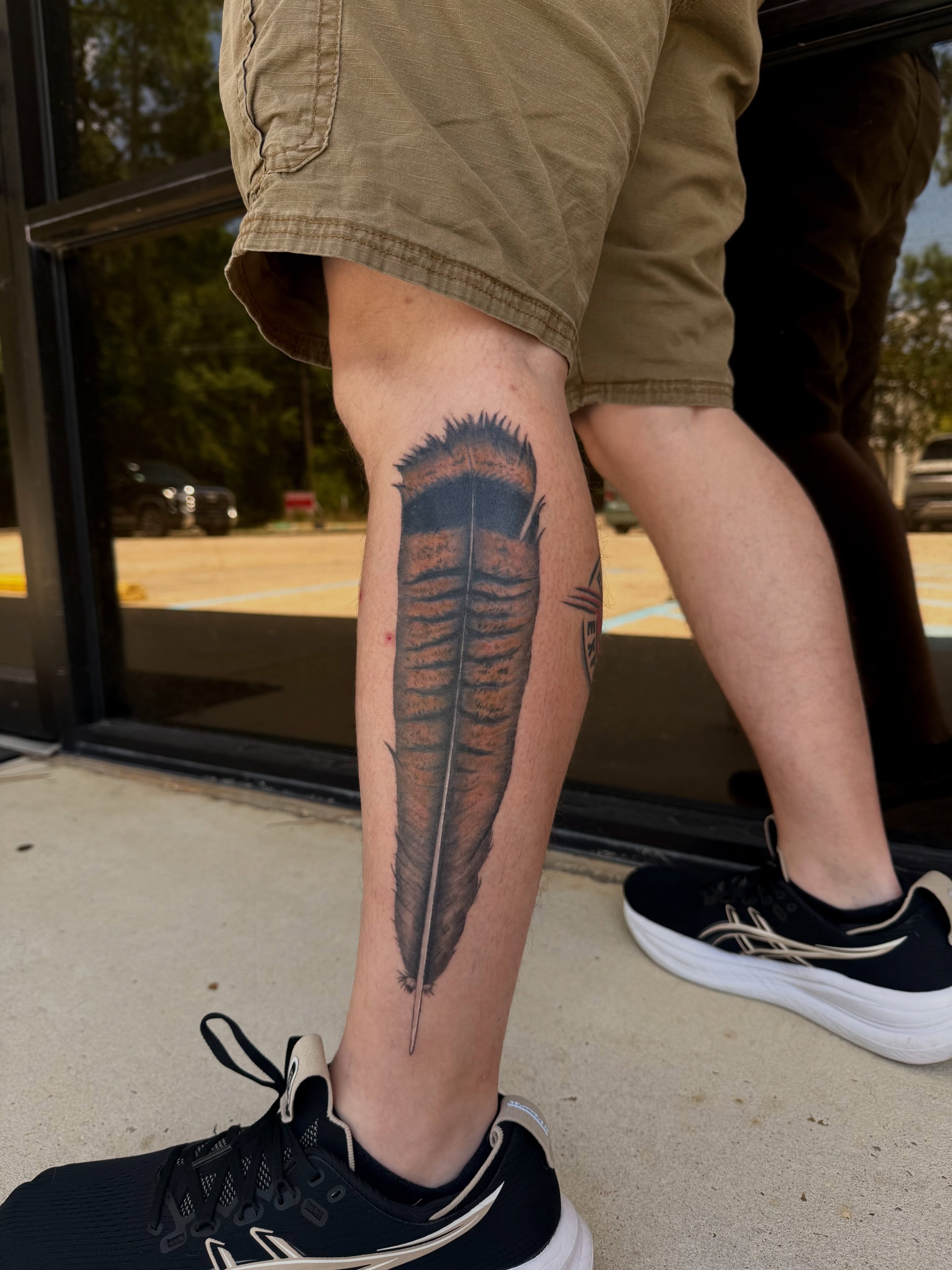 Feather realism tattoo on the calf by Shay - Mandeville Tattoo Artist