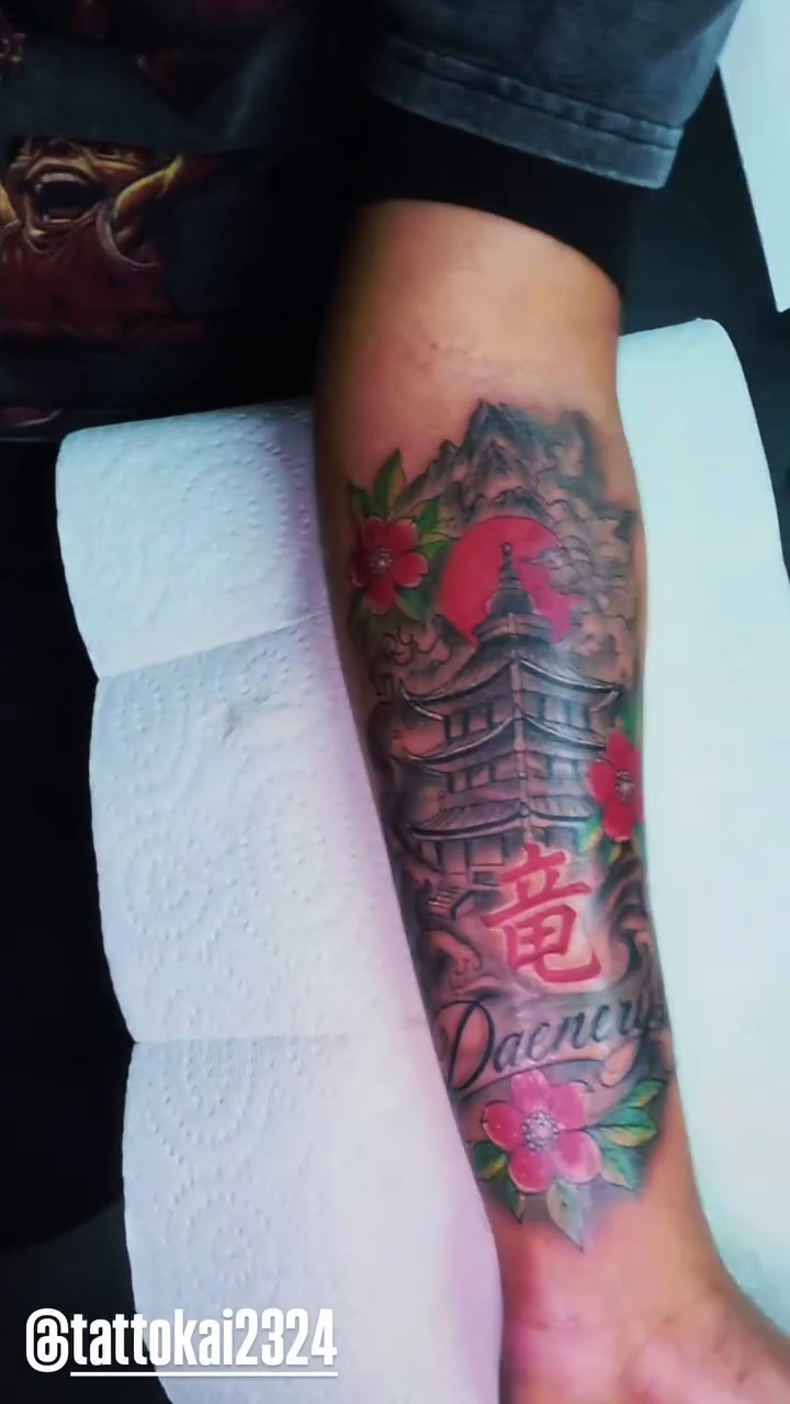 Japanese pagoda with script Japanese tattoo on the forearm by Kai_Tattoo
