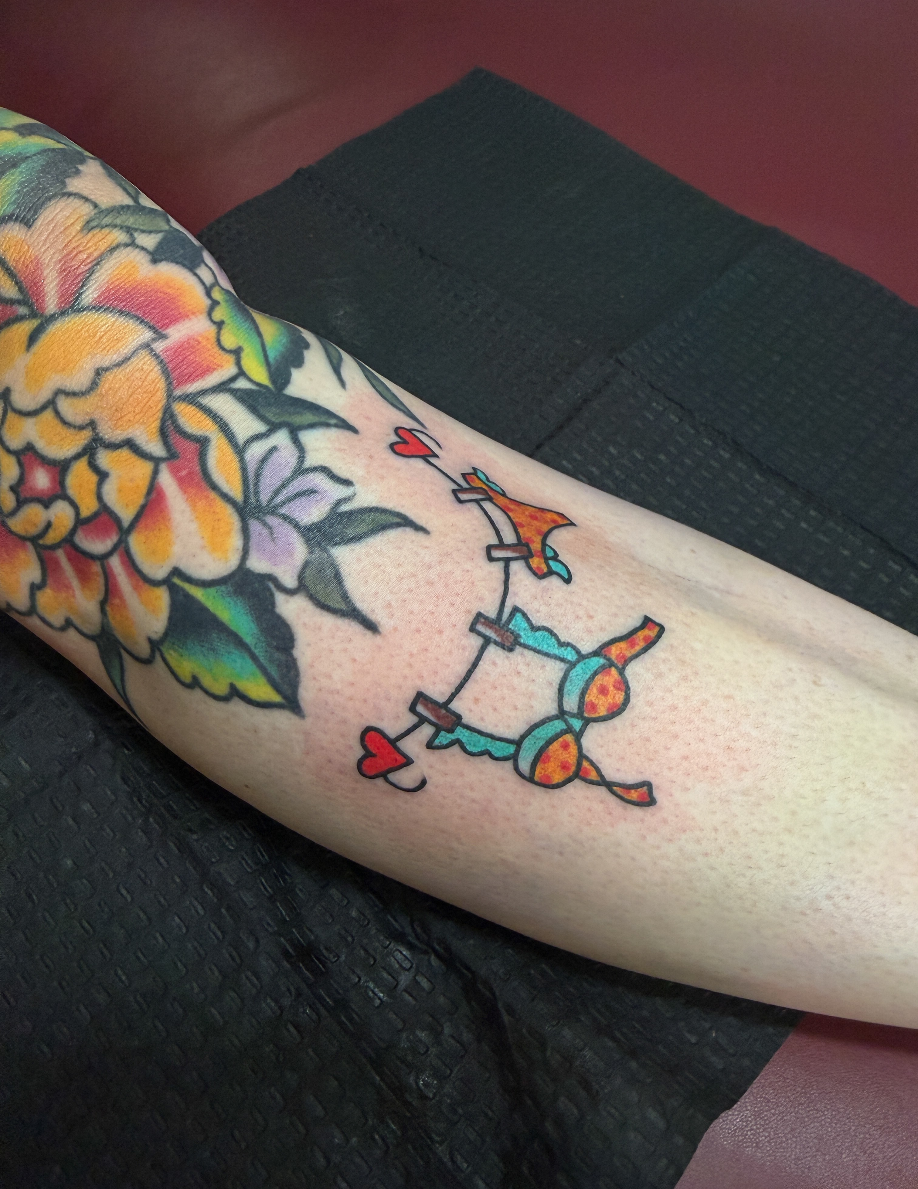 Bow and arrow American traditional tattoo on the forearm by Hannah Eddy