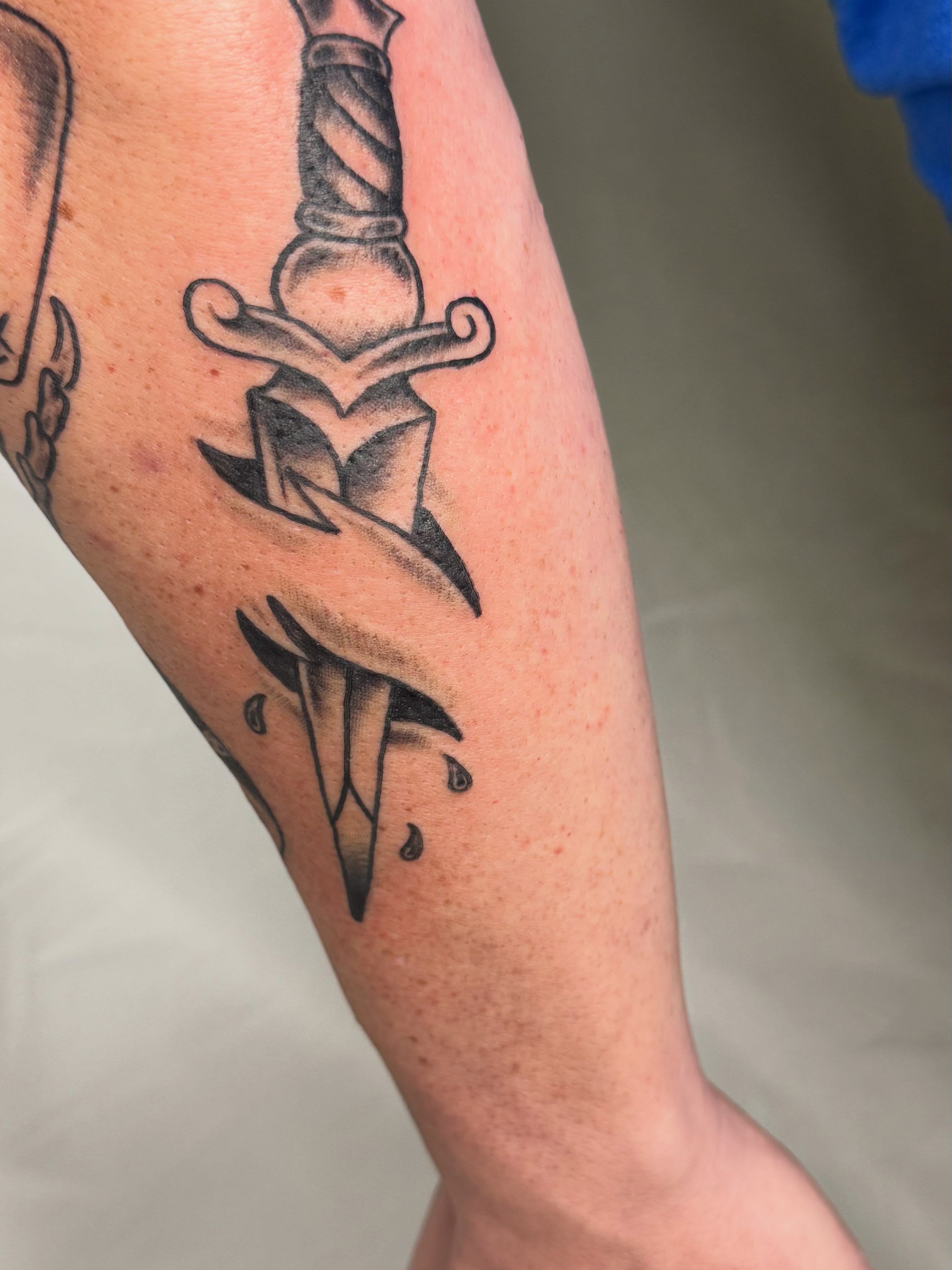 Sword and heart black and grey tattoo on the forearm by Elmer Lethco
