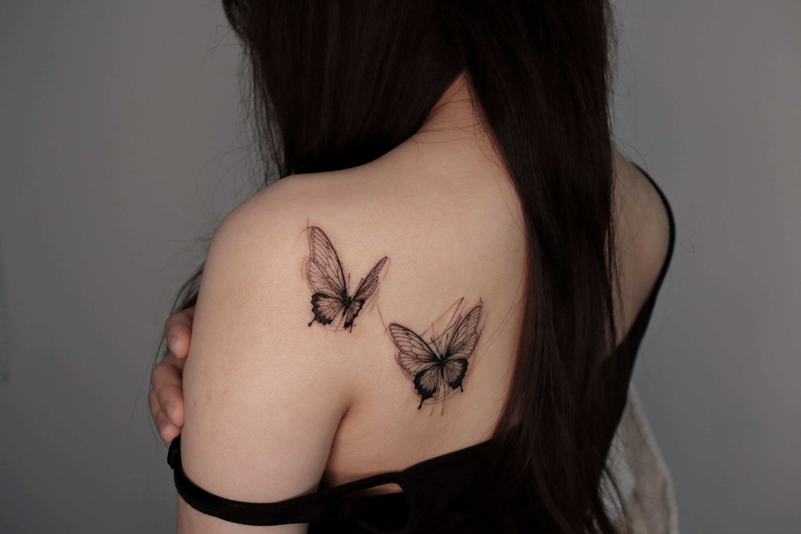 Butterflies black and grey tattoo on the shoulder by @tattoo_chamsae