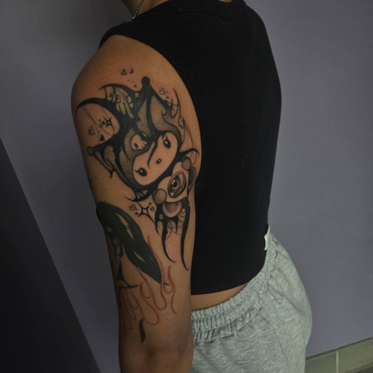 Abstract creature dotwork tattoo on the upper arm by Ema Fish