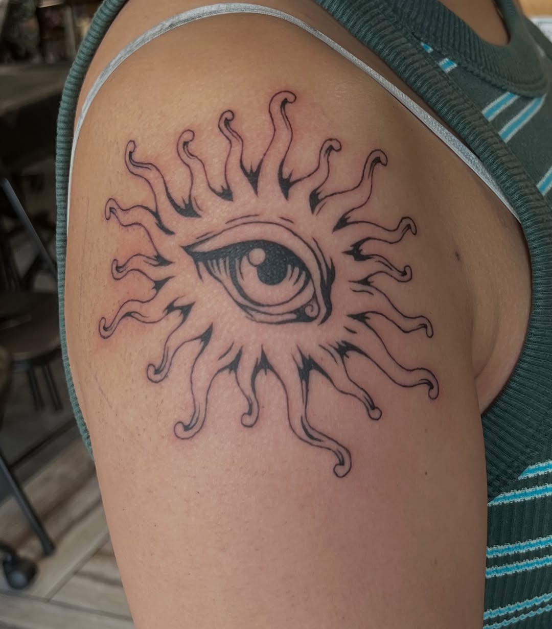 Eye sun geometric tattoo on the shoulder by Hayes