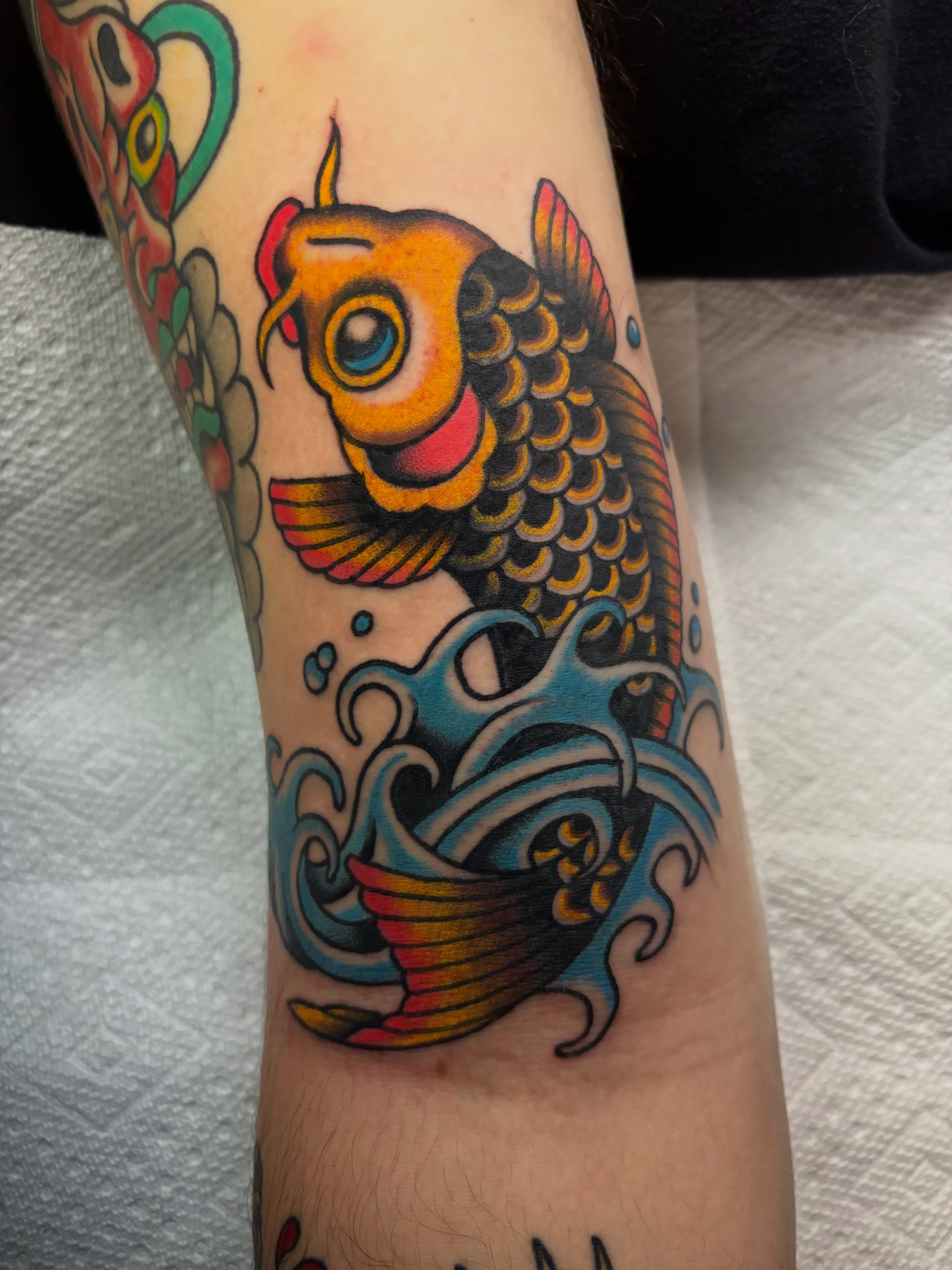 Koi fish American traditional tattoo on the forearm by Chris Dufresne