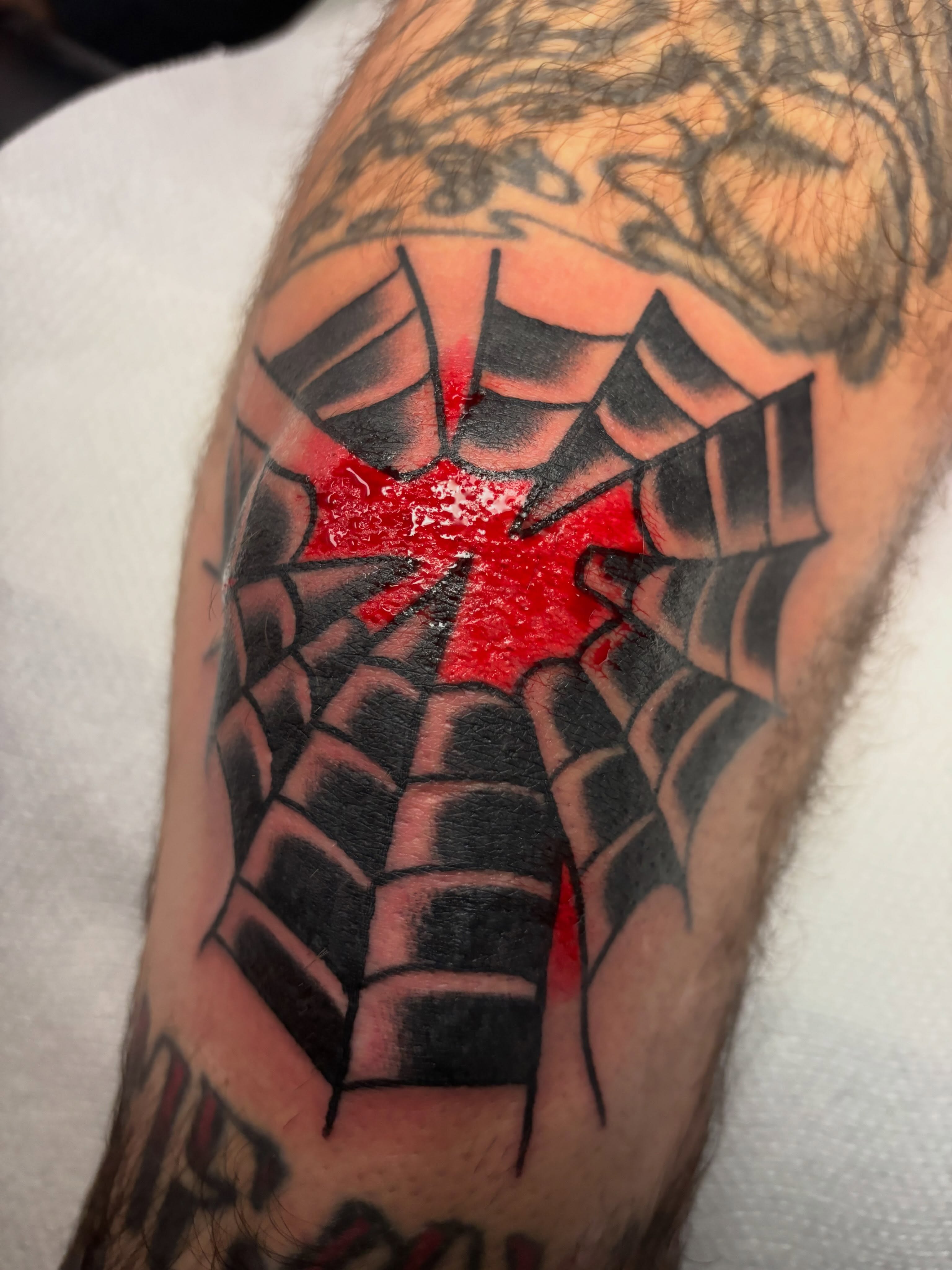Spider web geometric tattoo on the forearm by Chris Dufresne