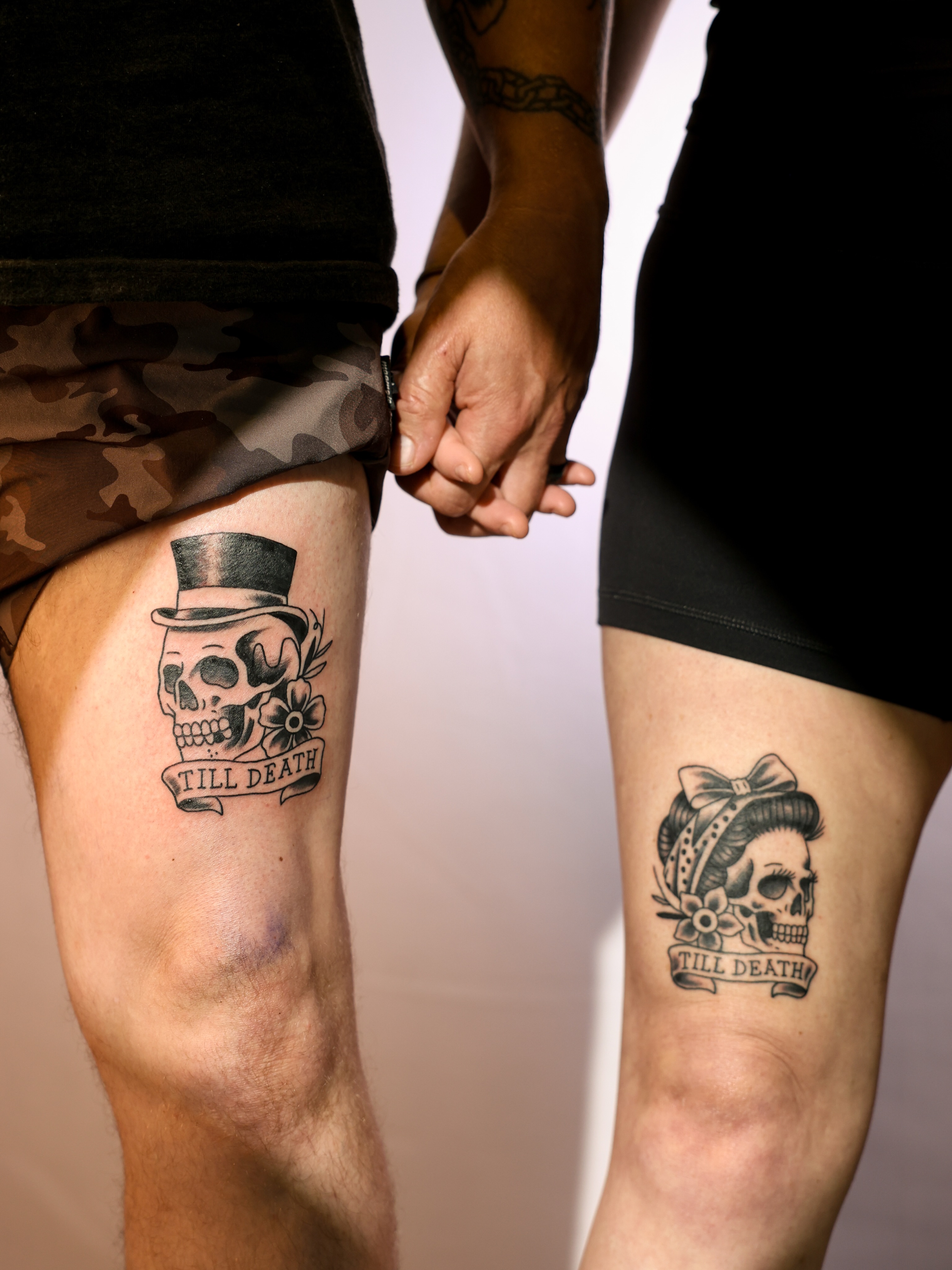Skulls and flowers black and grey tattoo on the thigh by Josh Brownell