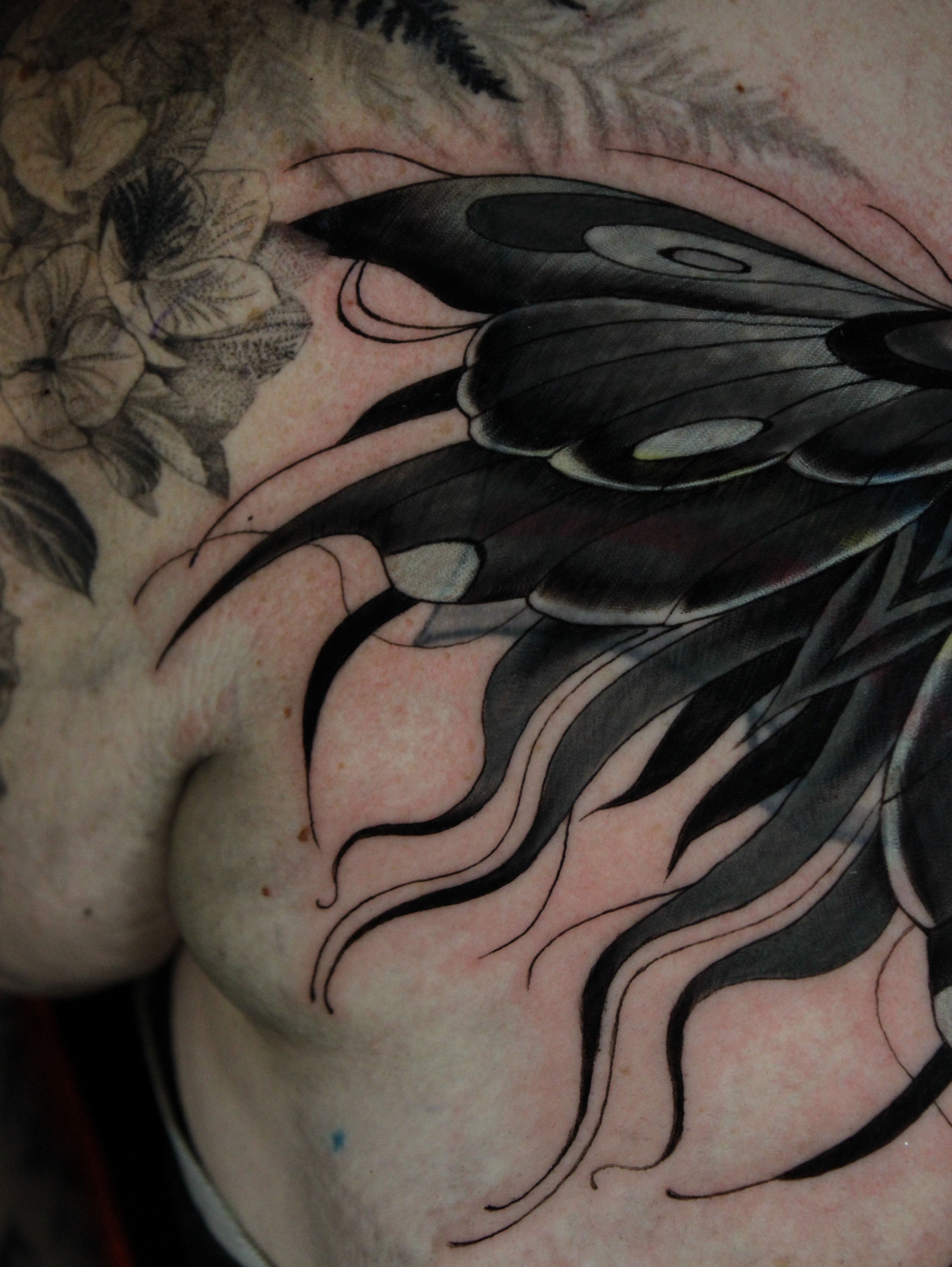 Butterfly black and grey tattoo on the chest by Eva Williams