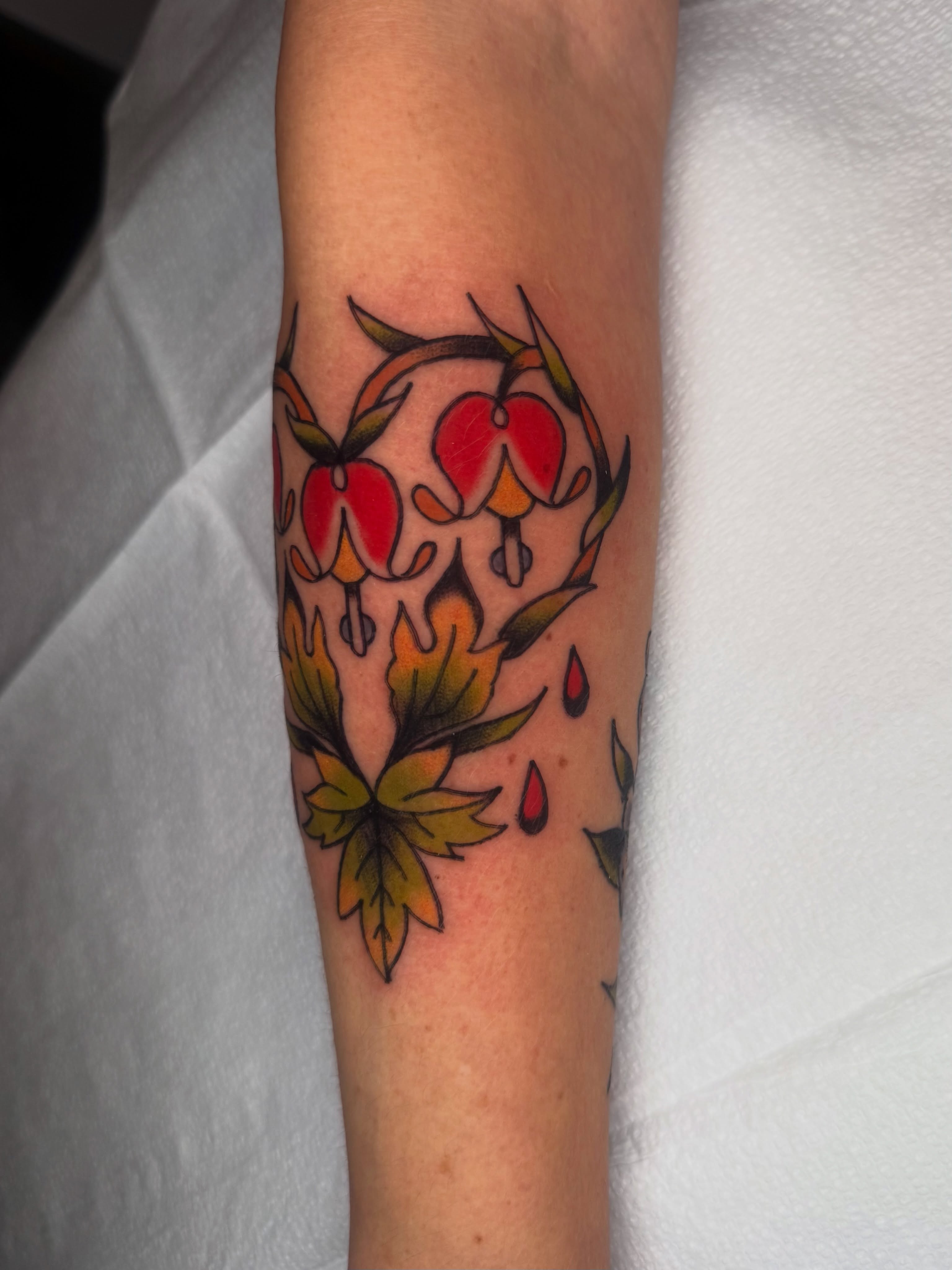 Drip flowers American traditional tattoo on the forearm by Lexie Graff