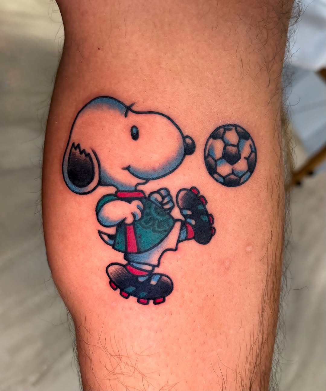 Soccer player Snoopy illustrative tattoo on the thigh by Louie Flores
