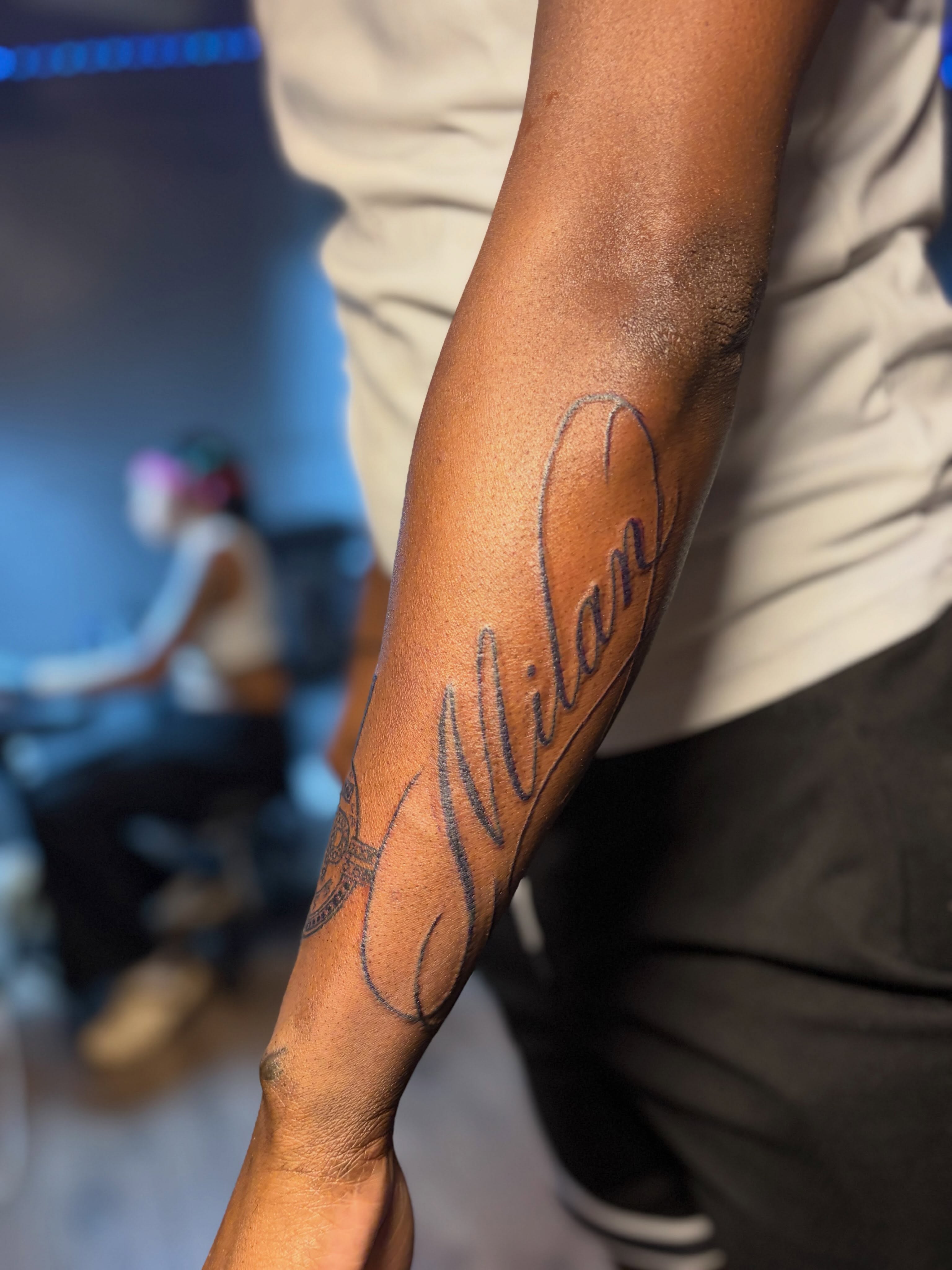 Name lettering script tattoo on the forearm by DC