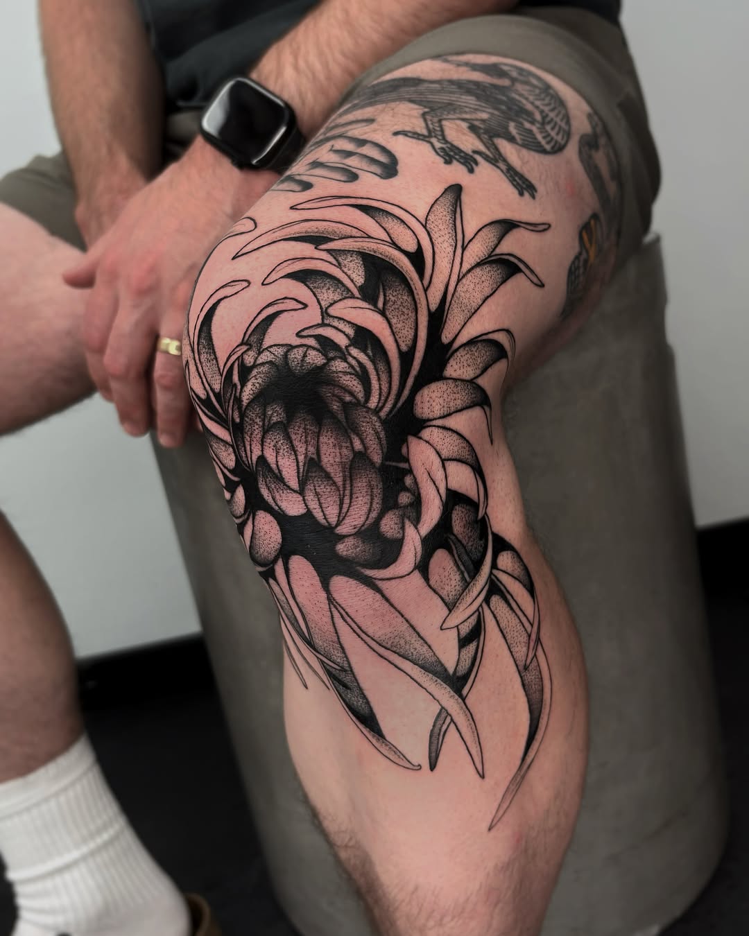Floral design dotwork tattoo on the thigh by Kuya, Berkeley, California