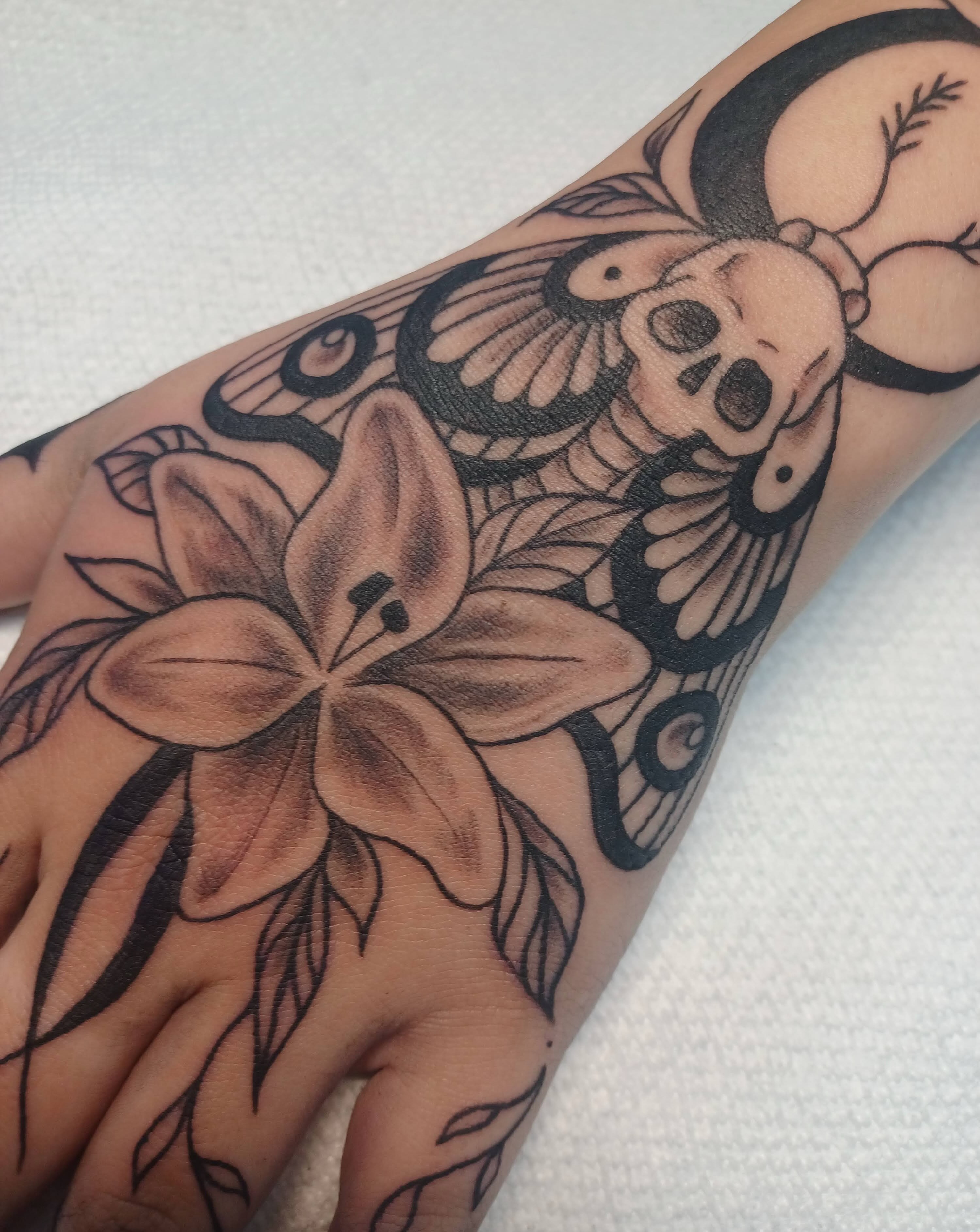 Lily and skull realism tattoo on the forearm by Abi