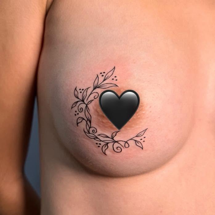 Heart black and grey tattoo on the chest by Destiny A