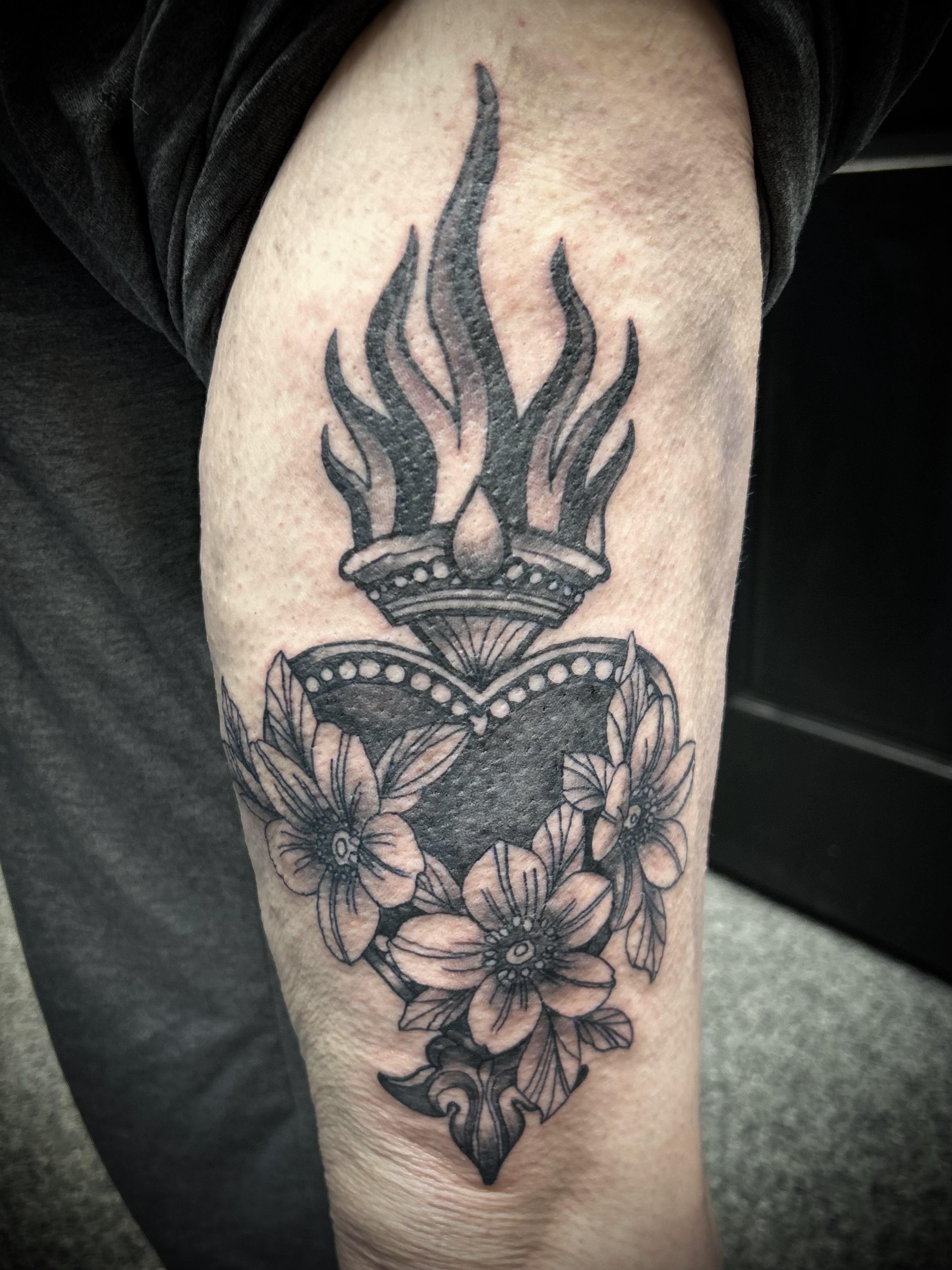 Flame and floral heart geometric tattoo on the thigh by Gillian