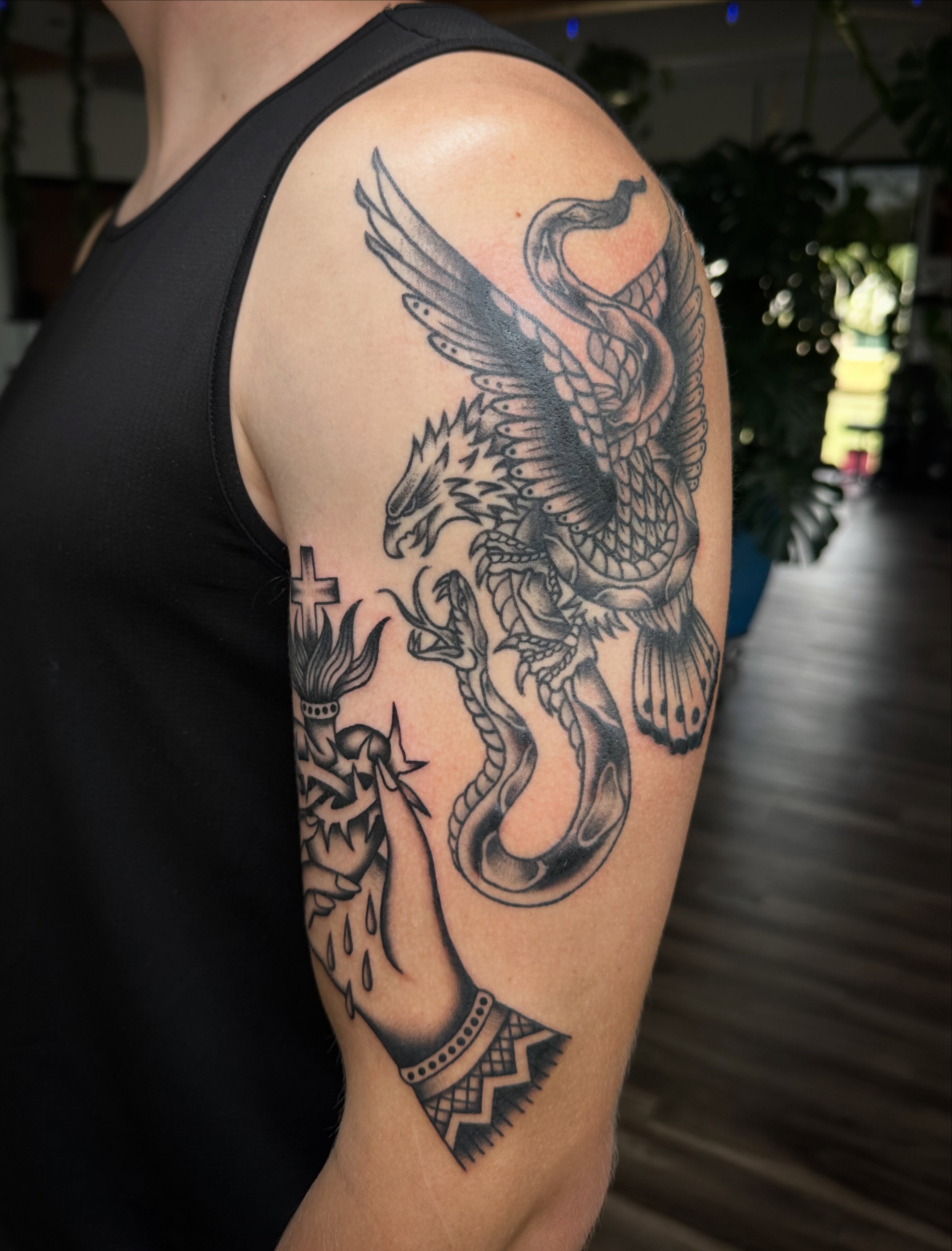 Eagle and snake black and grey tattoo on the upper arm by Jess Ritchie, Austin, Texas