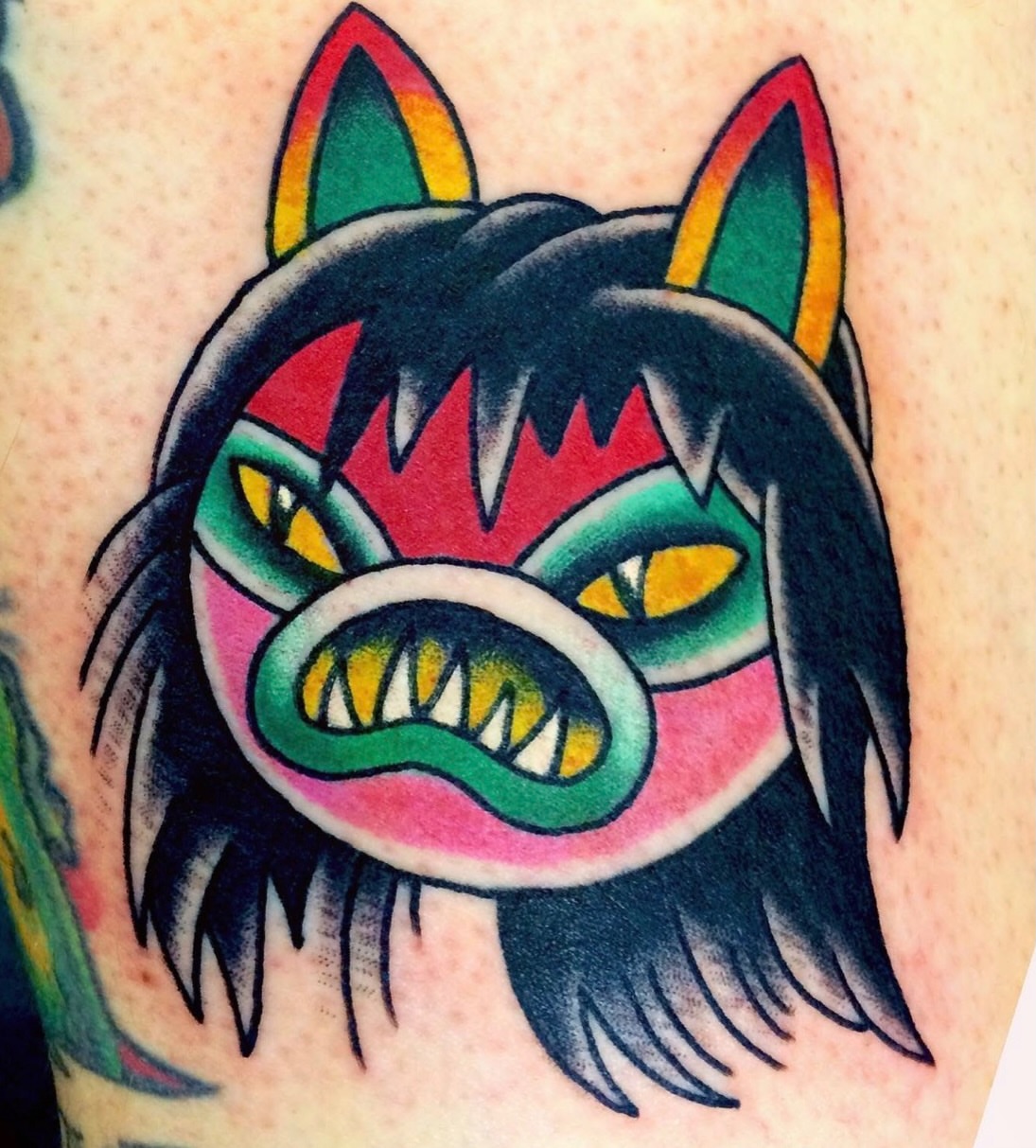Wolf head American traditional tattoo on the upper arm by Aidan Monahan Tattoo