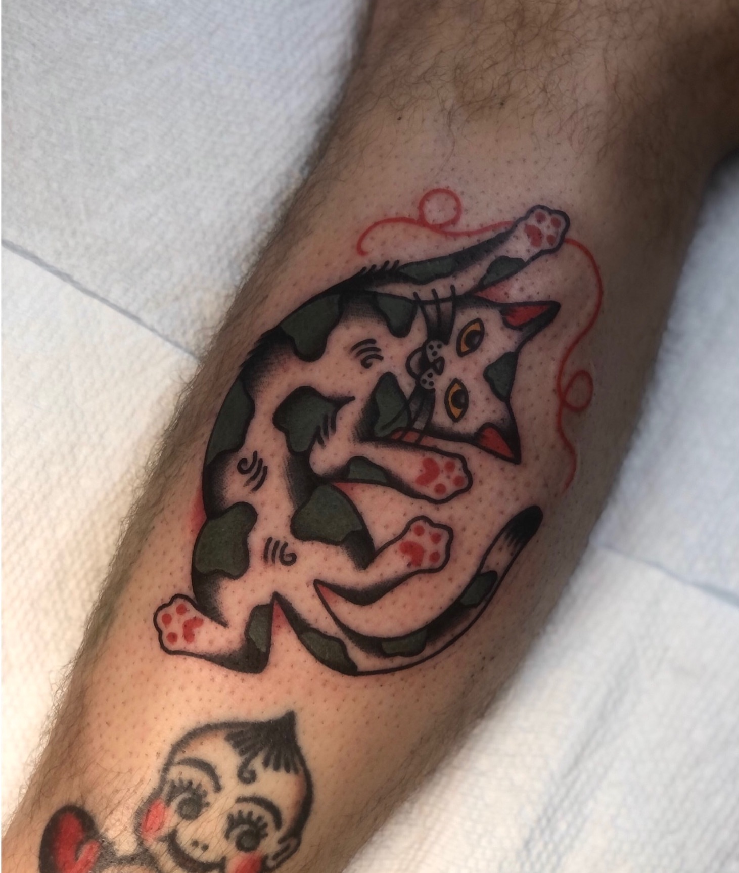 Cat American traditional tattoo on the forearm by EVA Traditional Tattoos