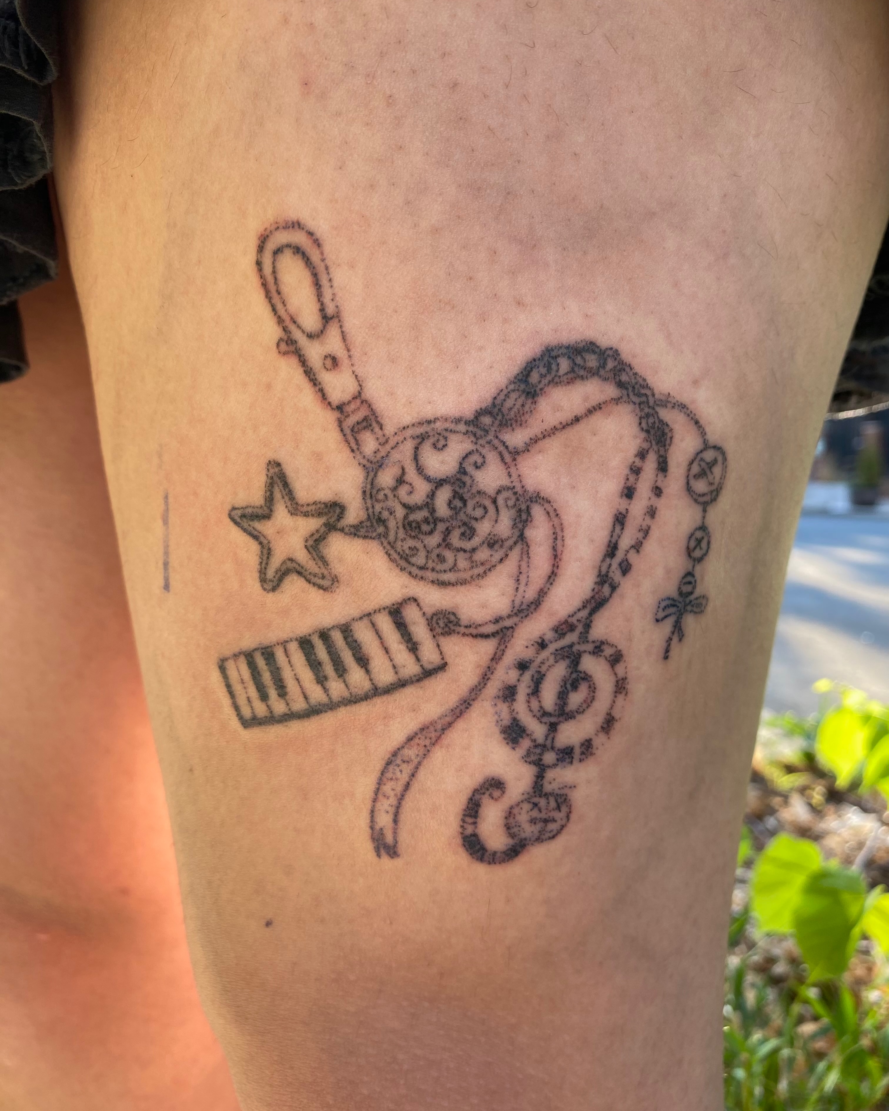 Music-themed black and grey tattoo on the thigh by @feverfeverish