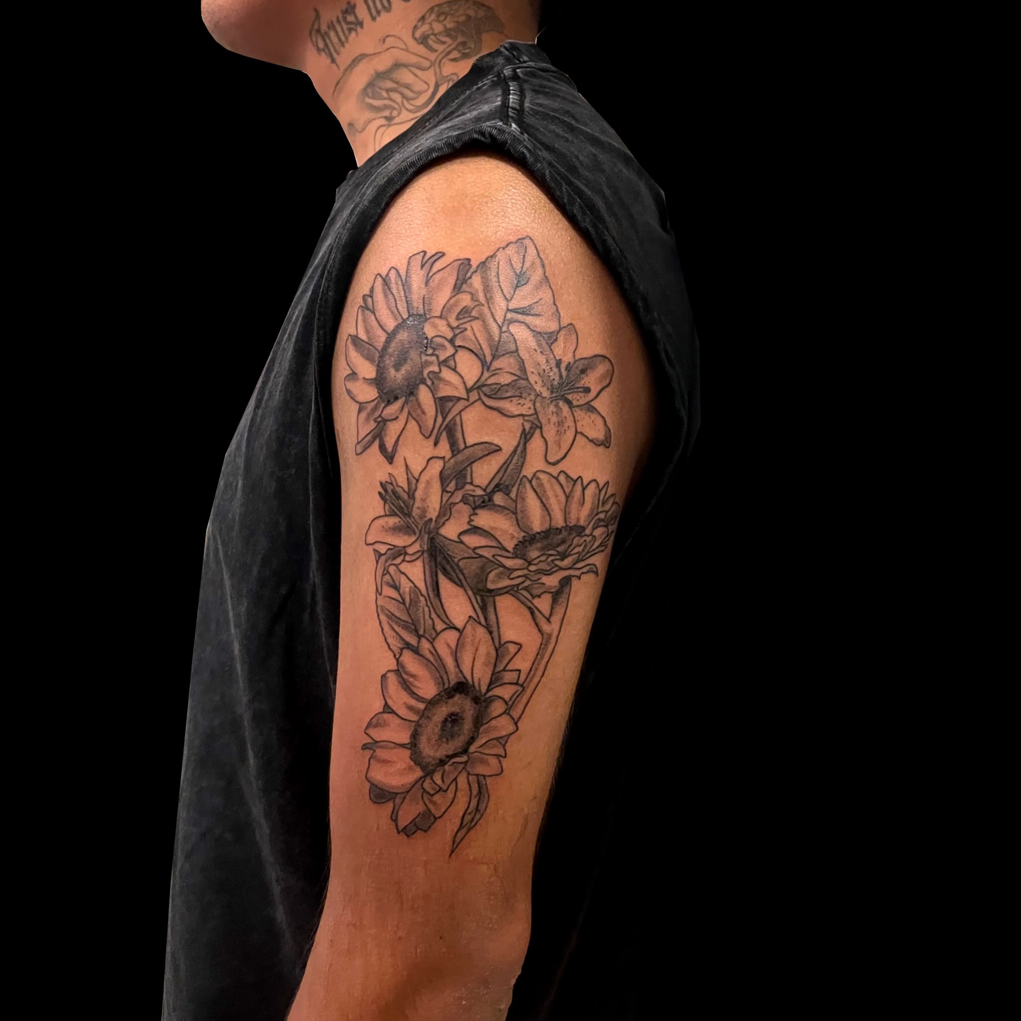Sunflowers black and grey tattoo on the upper arm by ren