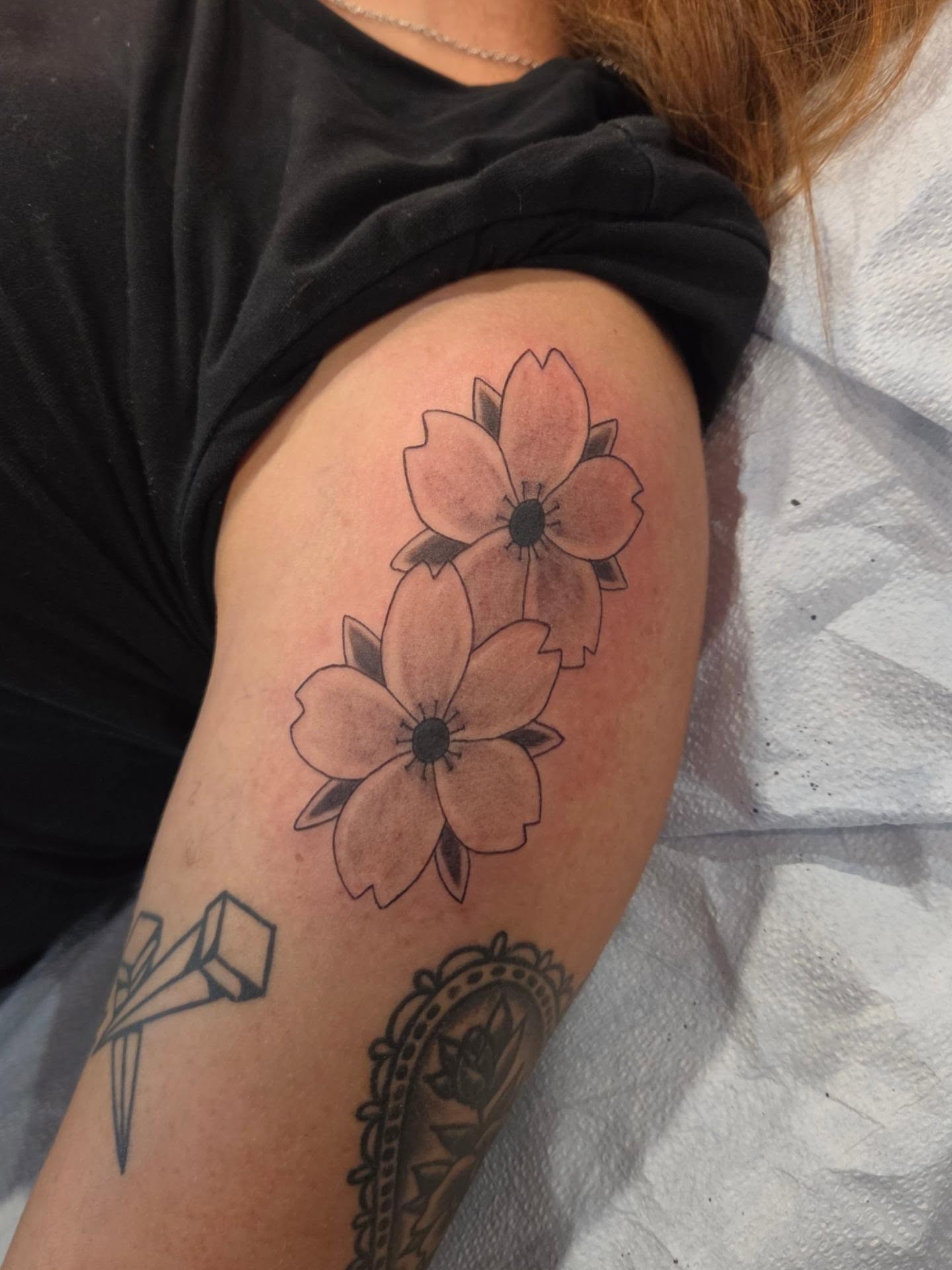 Flowers black and grey tattoo on the forearm by Jessica Duggan