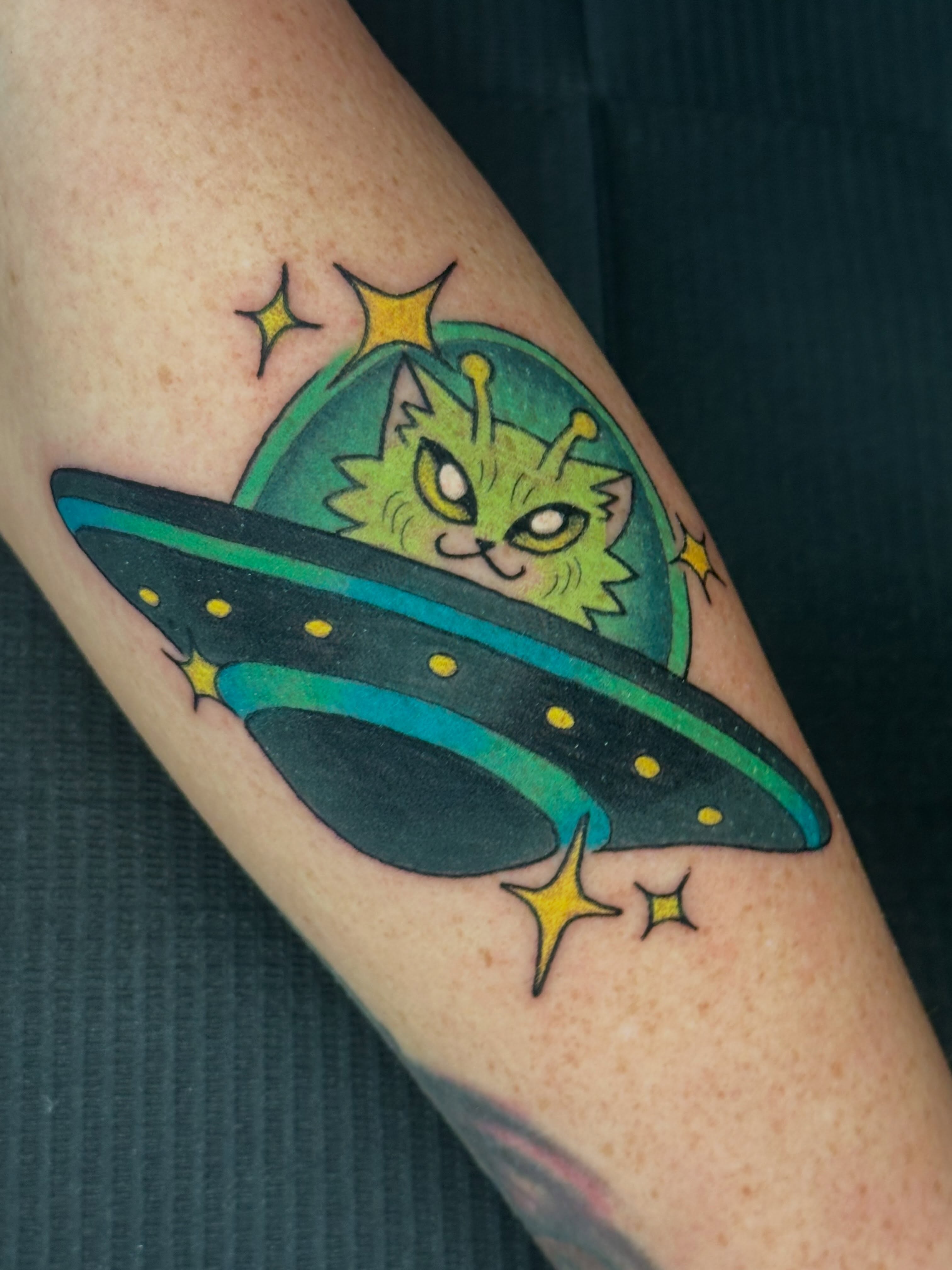 Alien cat in UFO new school tattoo on the forearm by liam u. williams