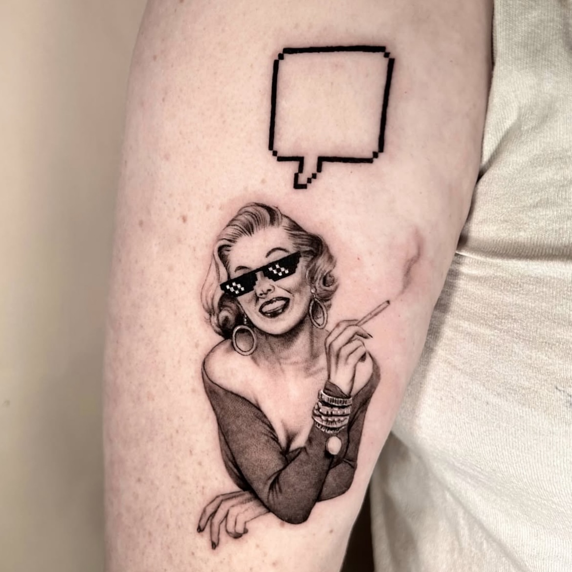 Pixelated speech bubble black and grey tattoo on the forearm by Longtea