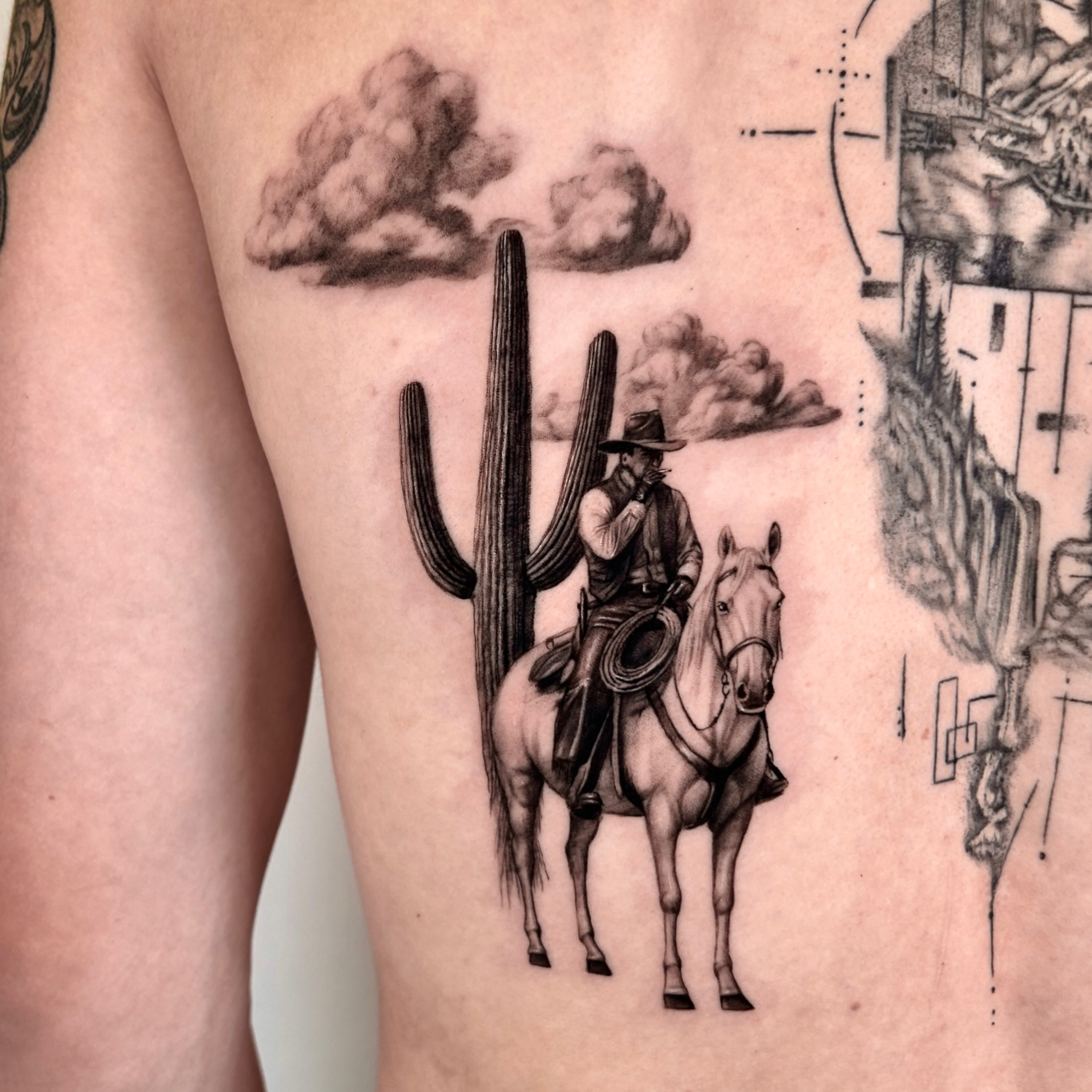 Cowboy on horse black and grey tattoo on the thigh by Longtea