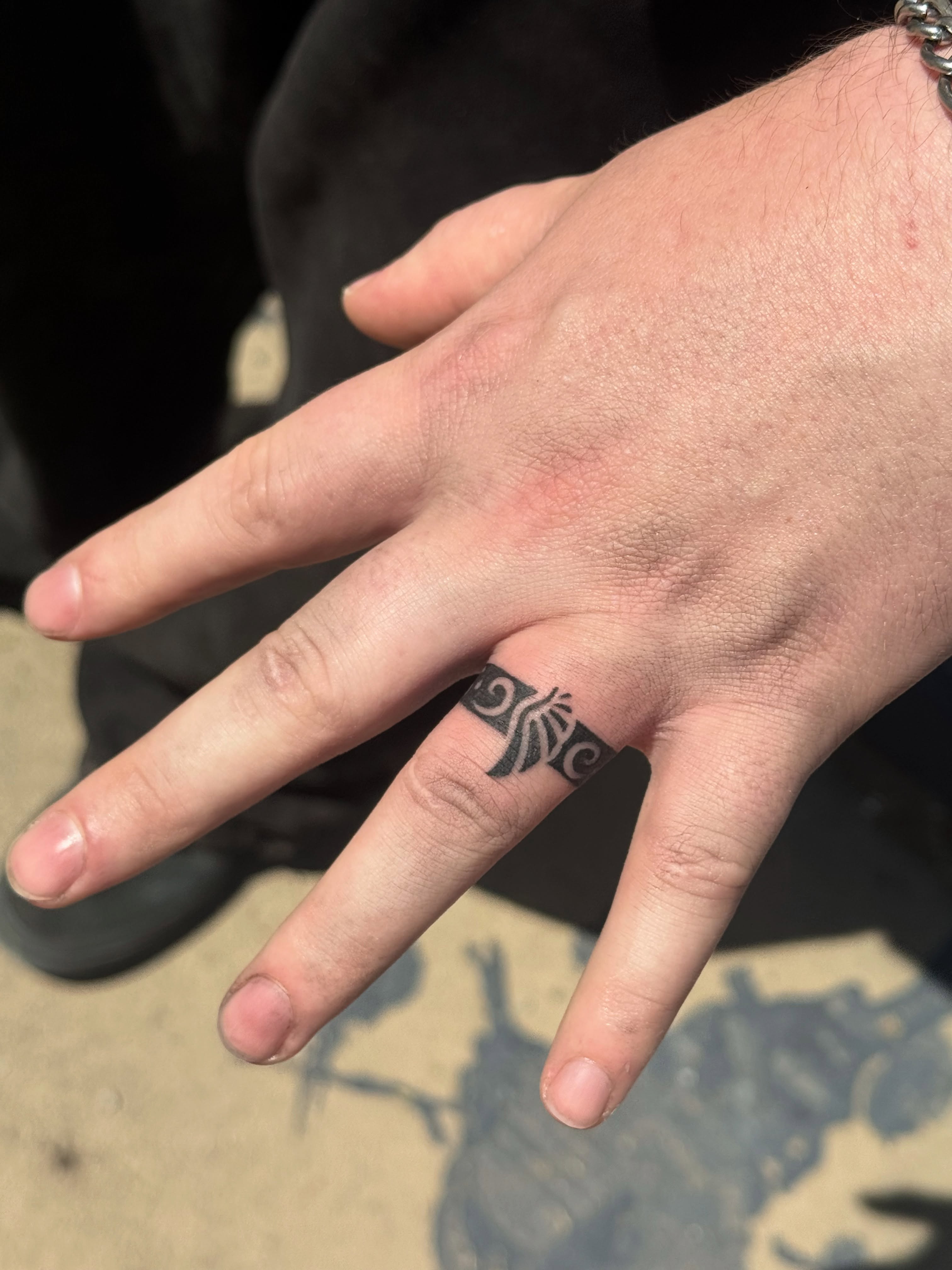 Scrollwork black and grey tattoo on the hand by Leti
