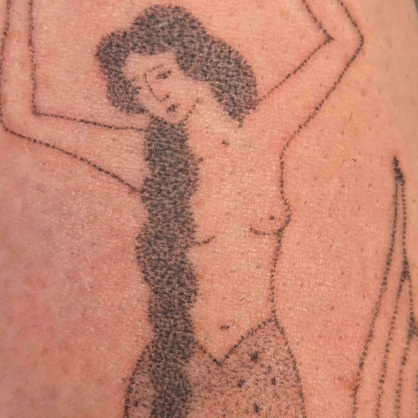 Woman dotwork tattoo on the upper arm by jules tattoos