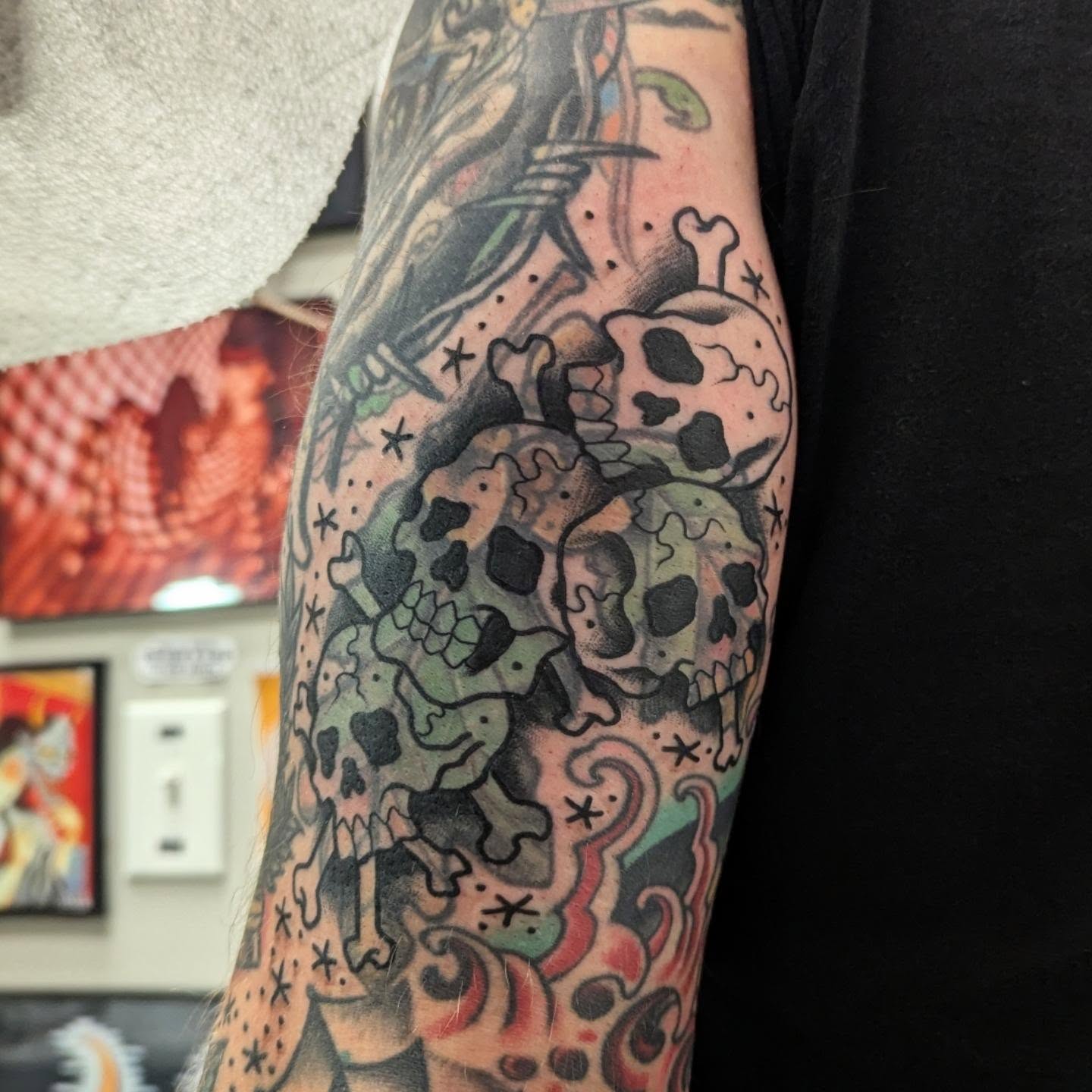 Skulls and bones American traditional tattoo on the forearm by Ryan Slegel