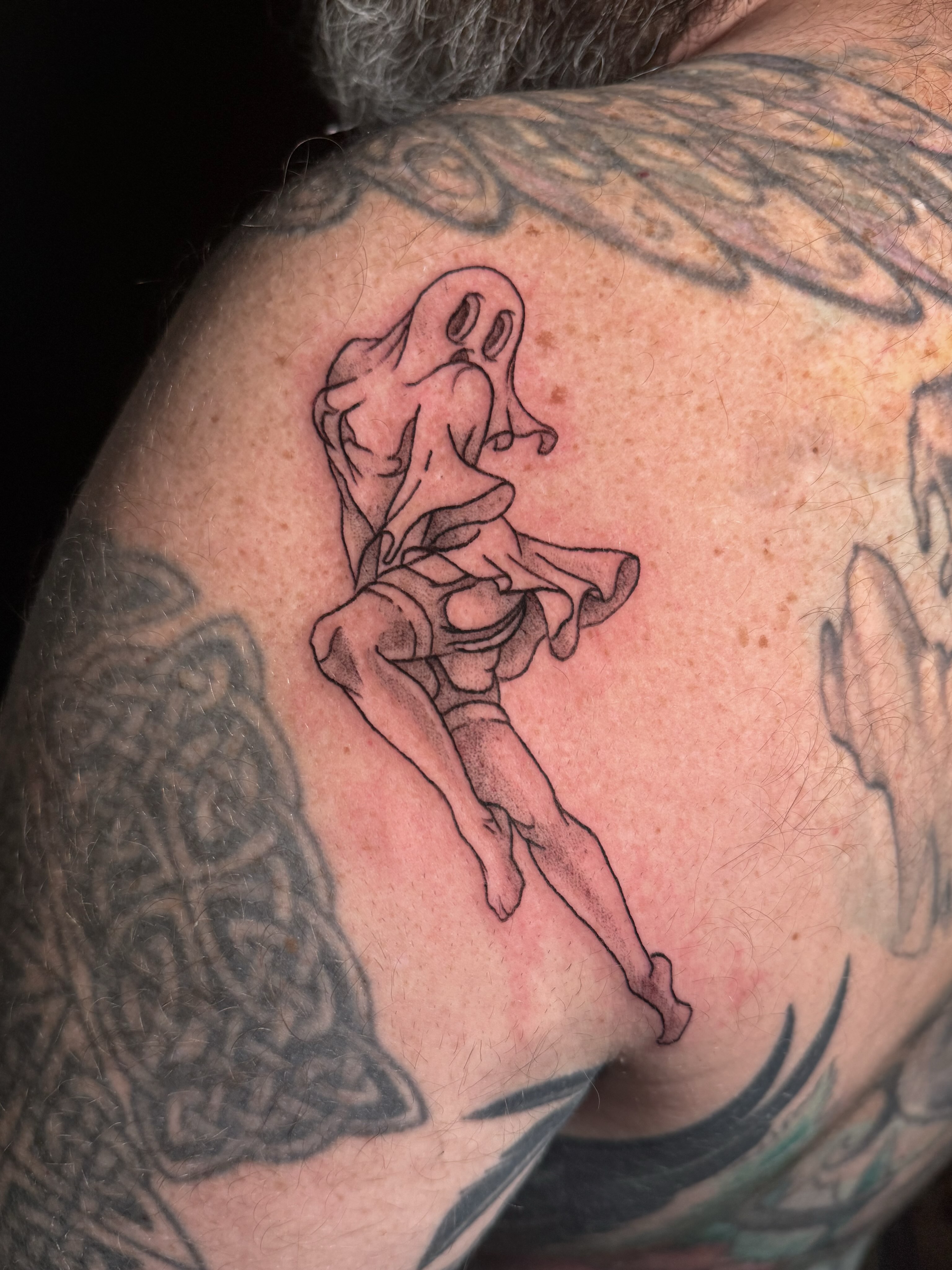 Ghostly figure black and grey tattoo on the shoulder by Ivy-Jade Edwards, Memphis, Tennessee