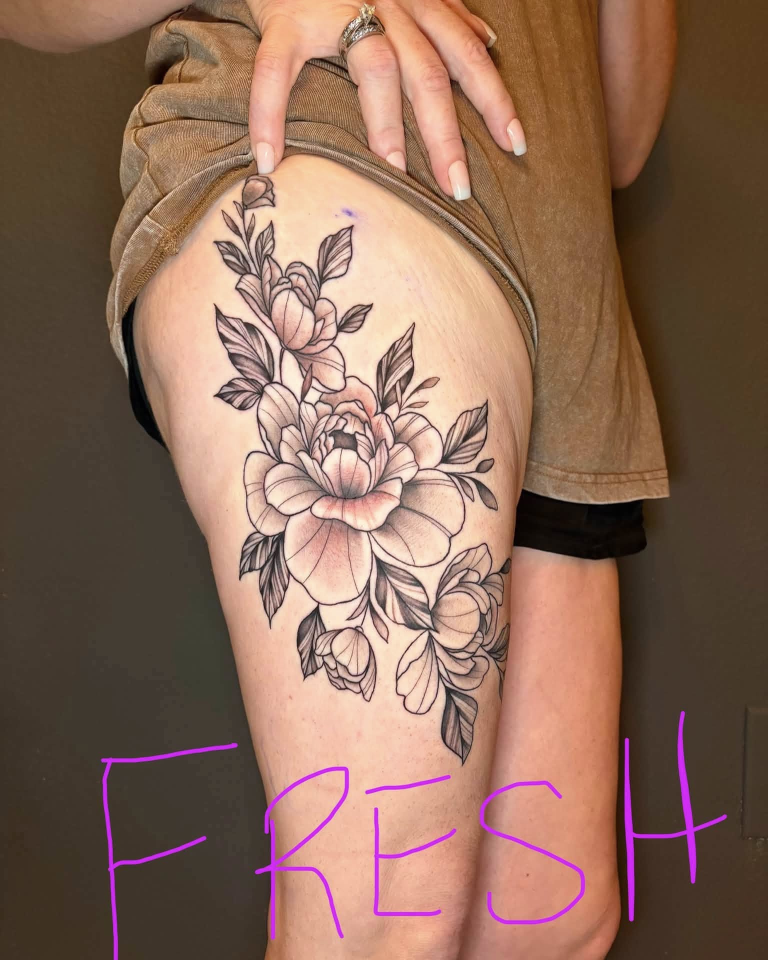 Floral bouquet black and grey tattoo on the thigh by Rachel Sellers