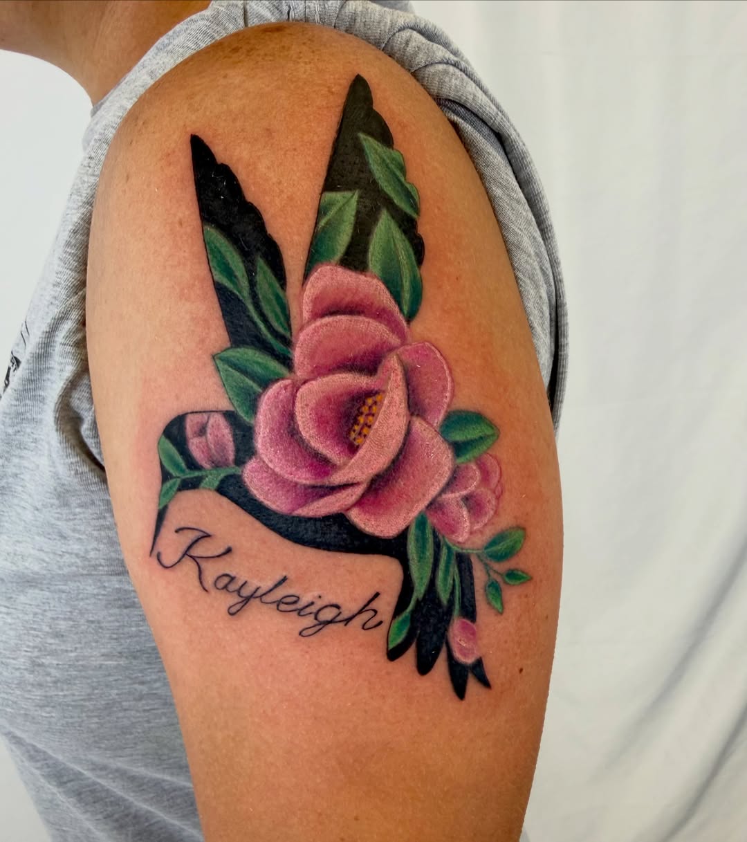 Flower and name American traditional tattoo on the shoulder by Jerry Thomas
