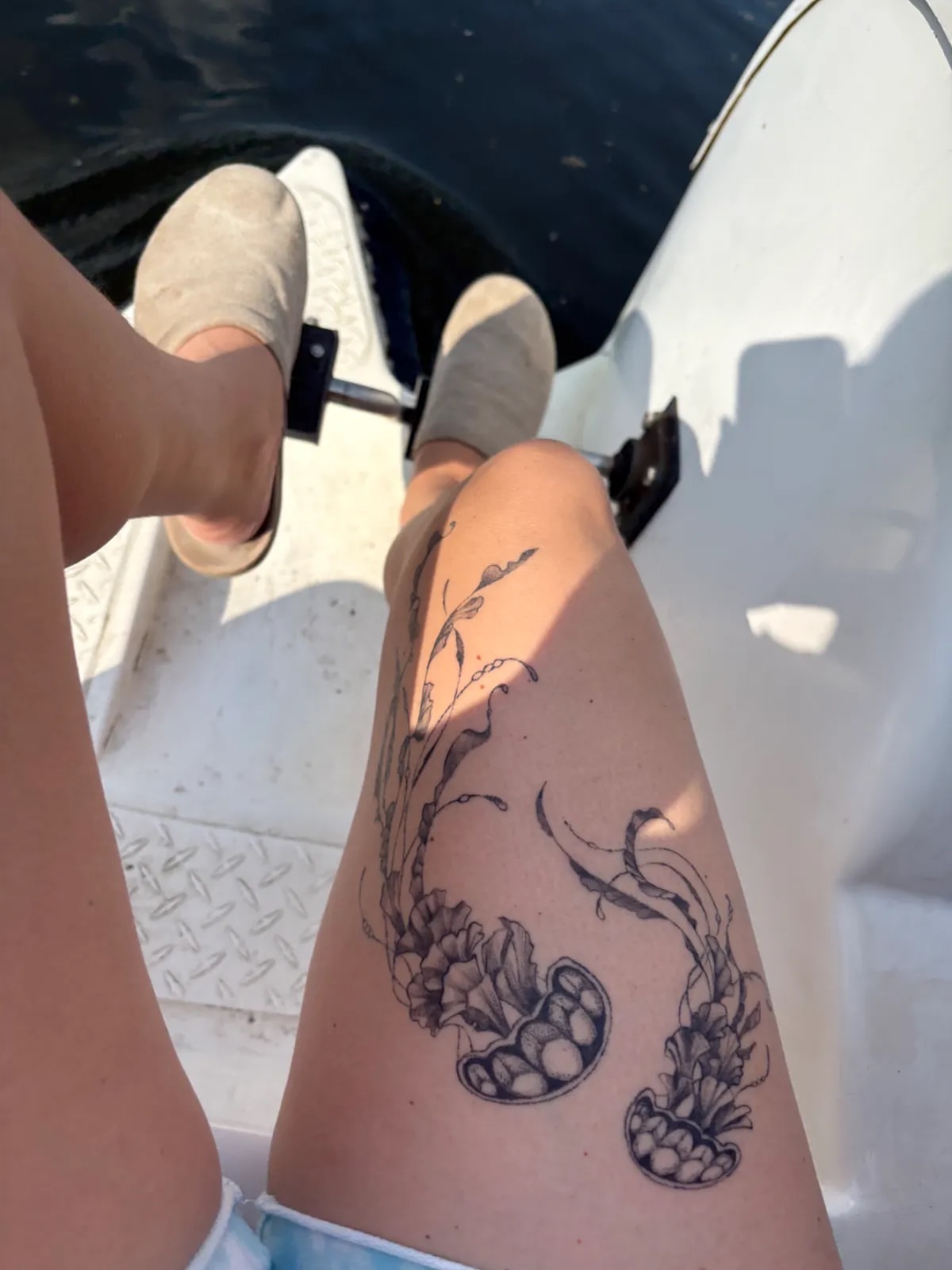 Peony and grapes black and grey tattoo on the thigh by Sadie Spades Philly Tattoos