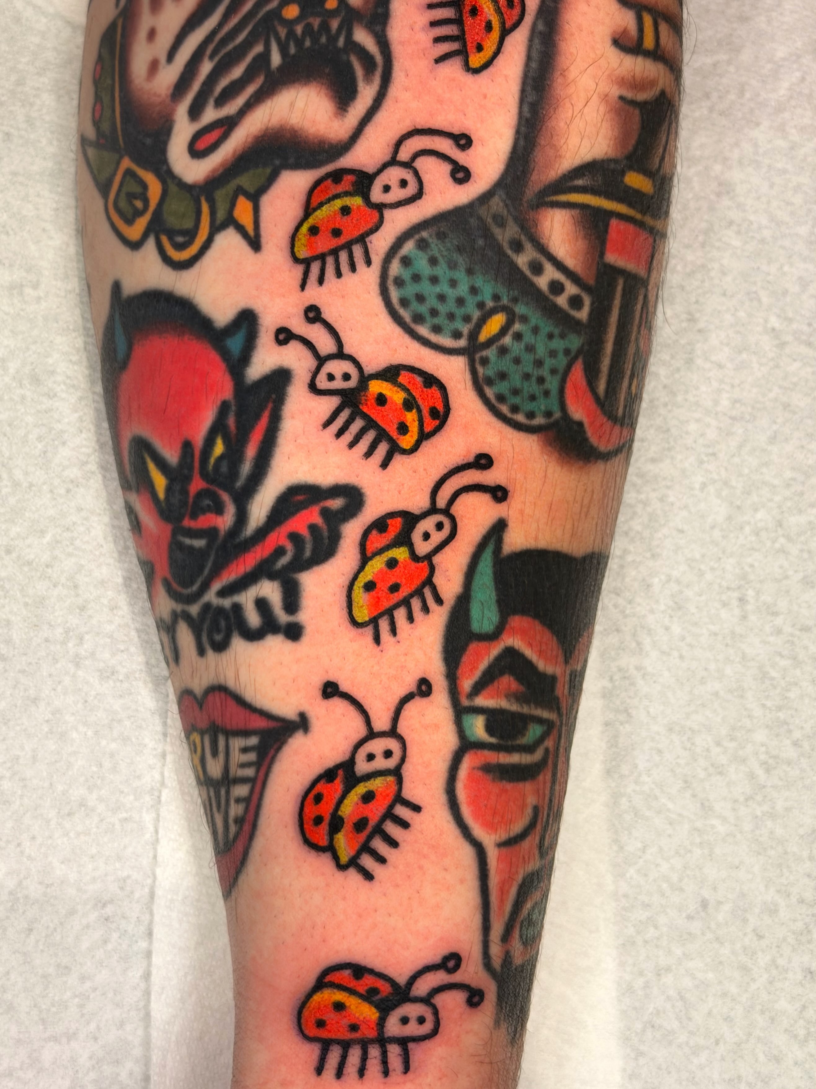 Ladybugs American traditional tattoo on the forearm by Jake