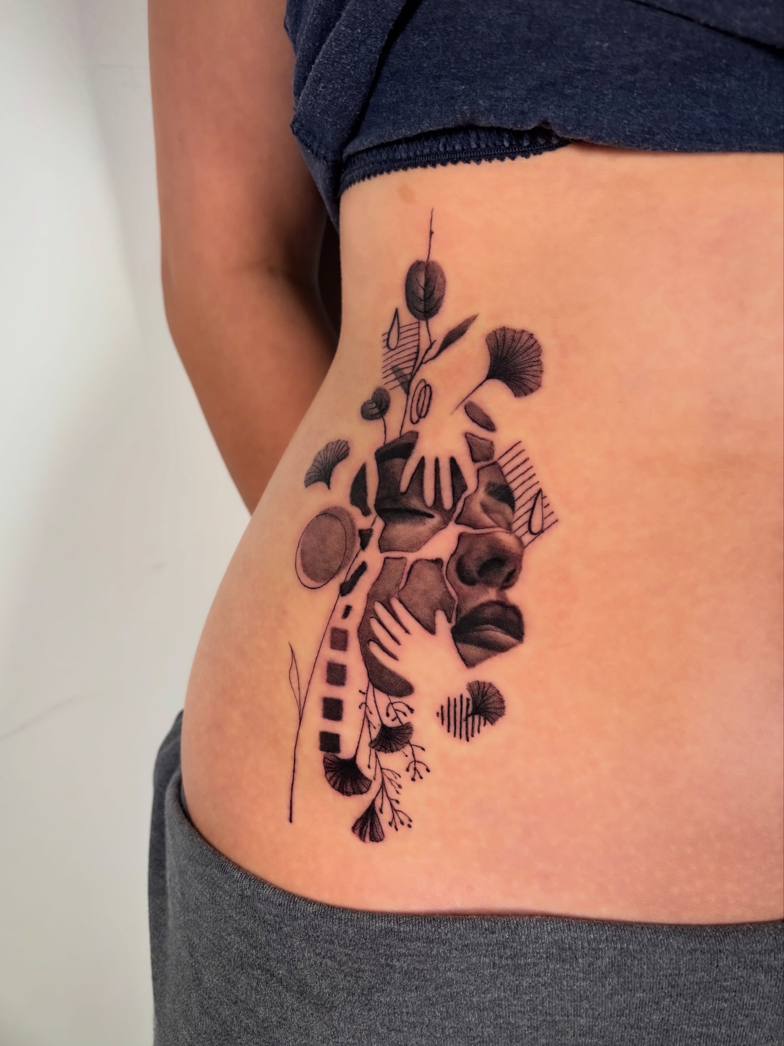 Abstract botanical geometric tattoo on the ribs by Dani