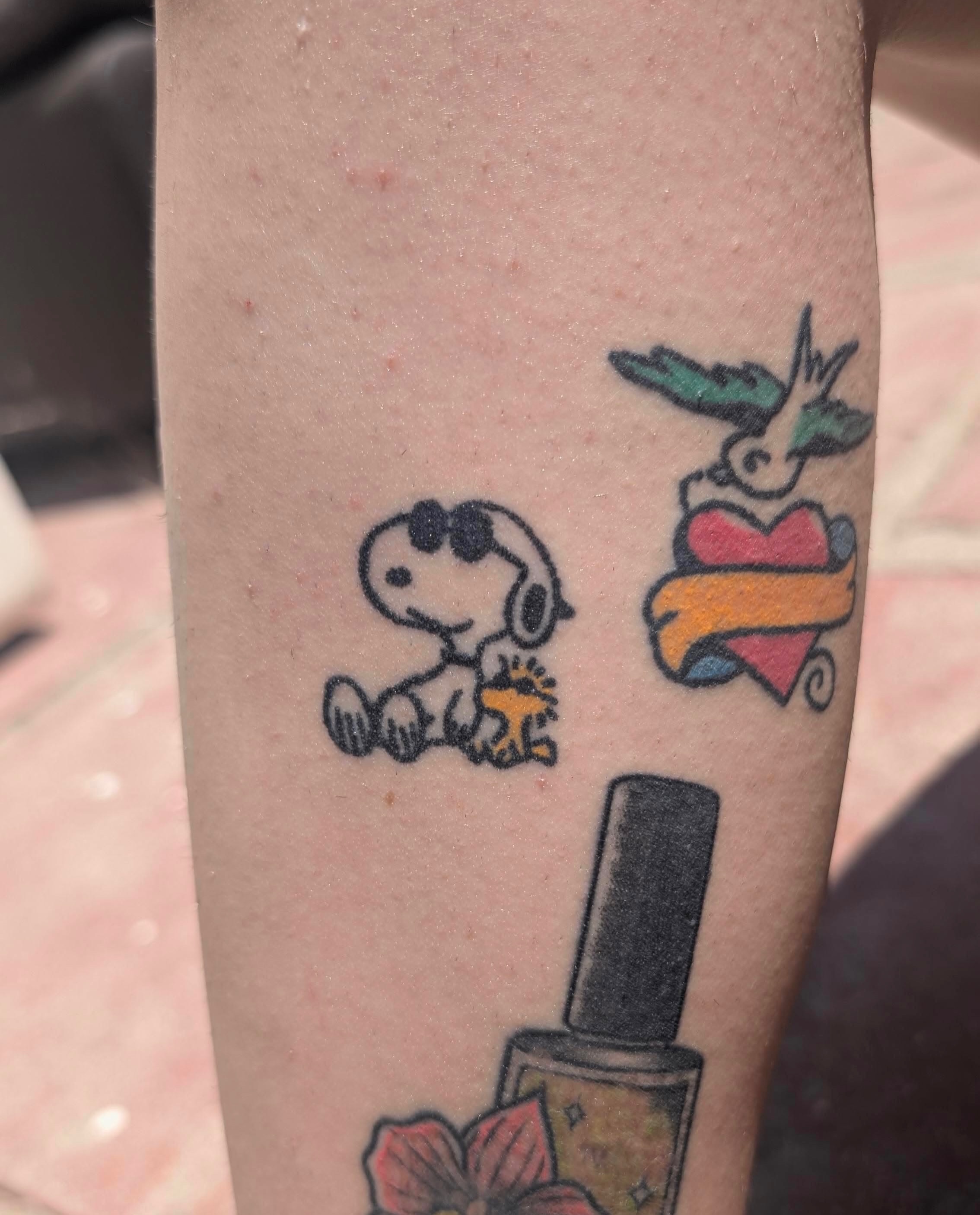 Snoopy American traditional tattoo on the forearm by paulina