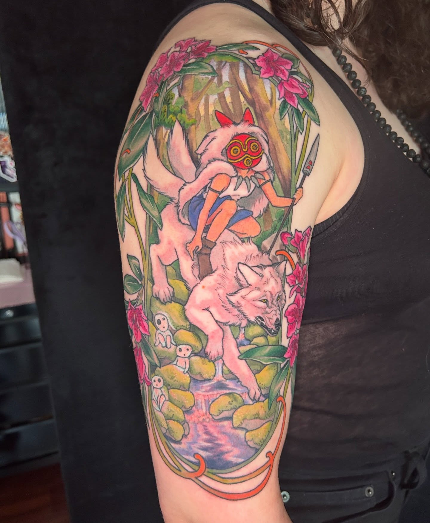Mononoke hime and wolves anime tattoo on the upper arm by Anna Sylvan Tattoos