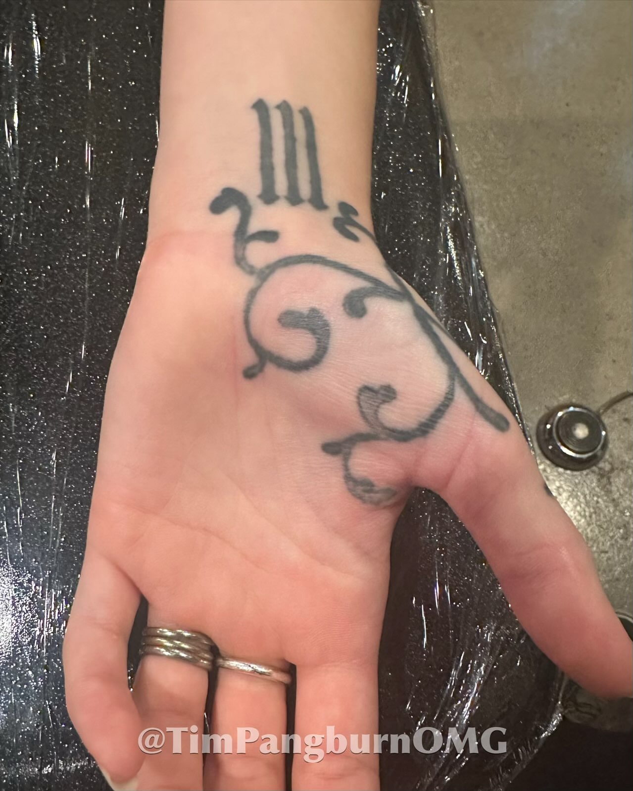 Scrollwork ornamental tattoo on the hand by Timothy Pangburn