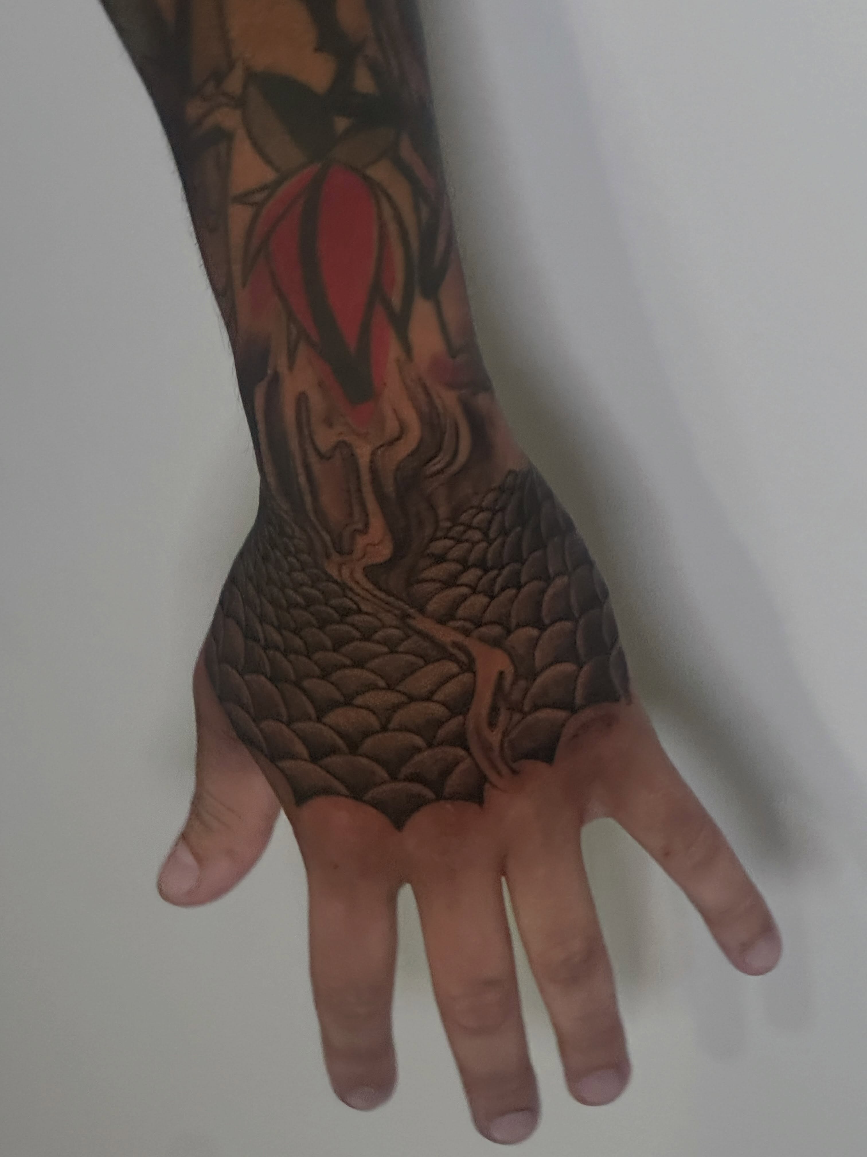 Dragon scales black and grey tattoo on the hand by Javierr Jimenezz