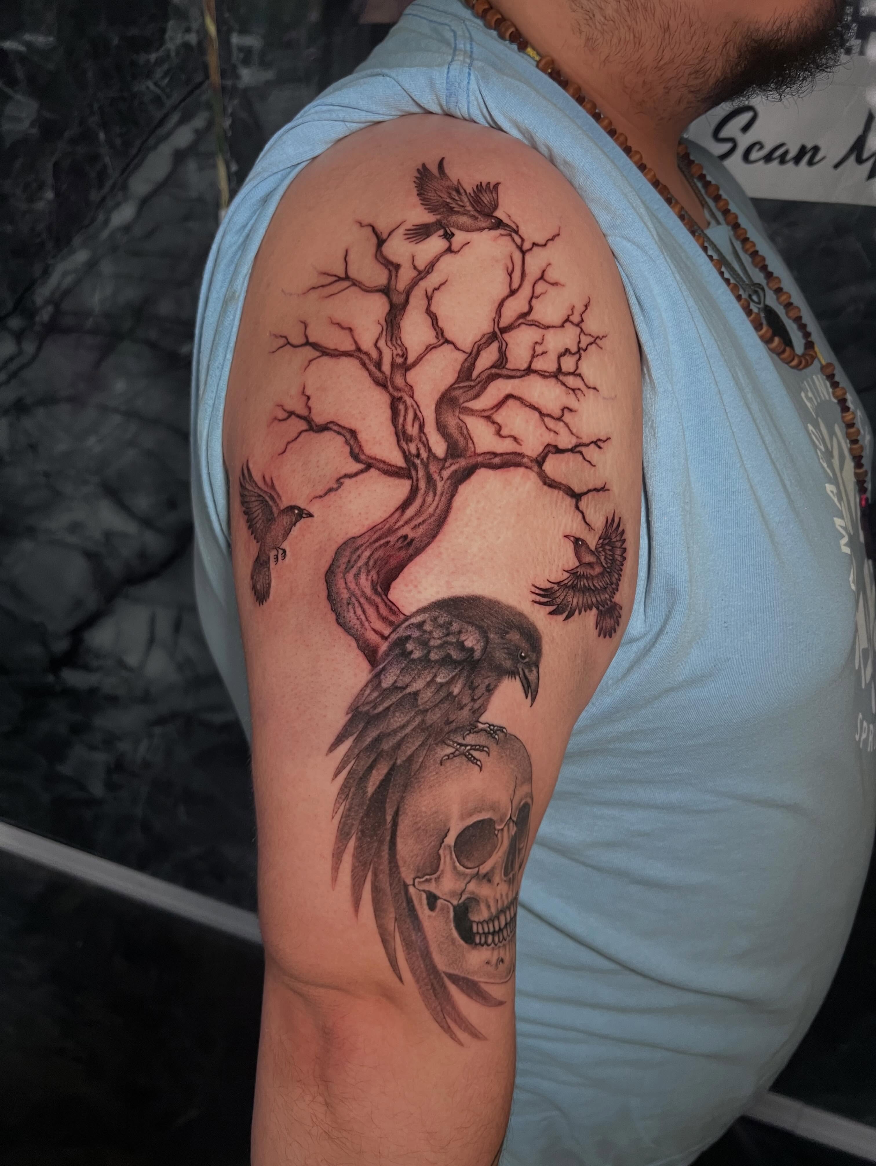 Skull with raven and tree tattoo on the shoulder by Gerardo Galicia, New York, New York