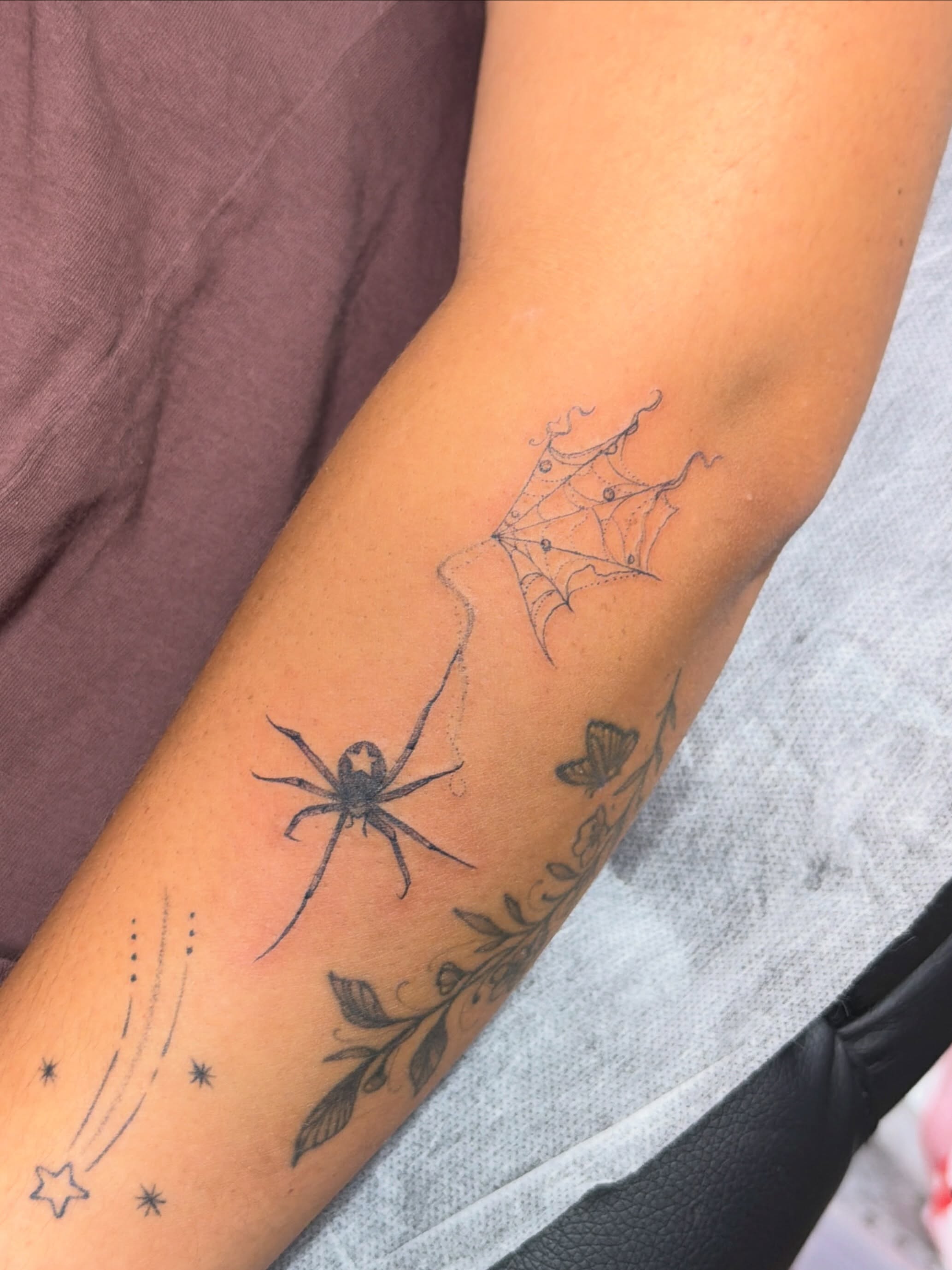 Spider and web black and grey tattoo on the forearm by Sienna (jj) Hicks