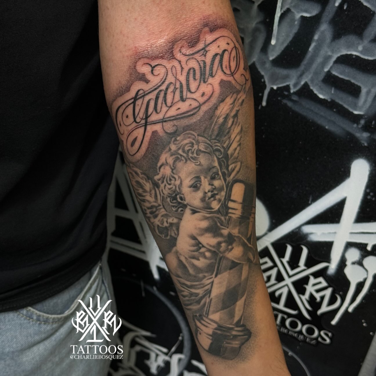 Cherub with trumpet realism tattoo on the forearm by El Beaver Tattoos