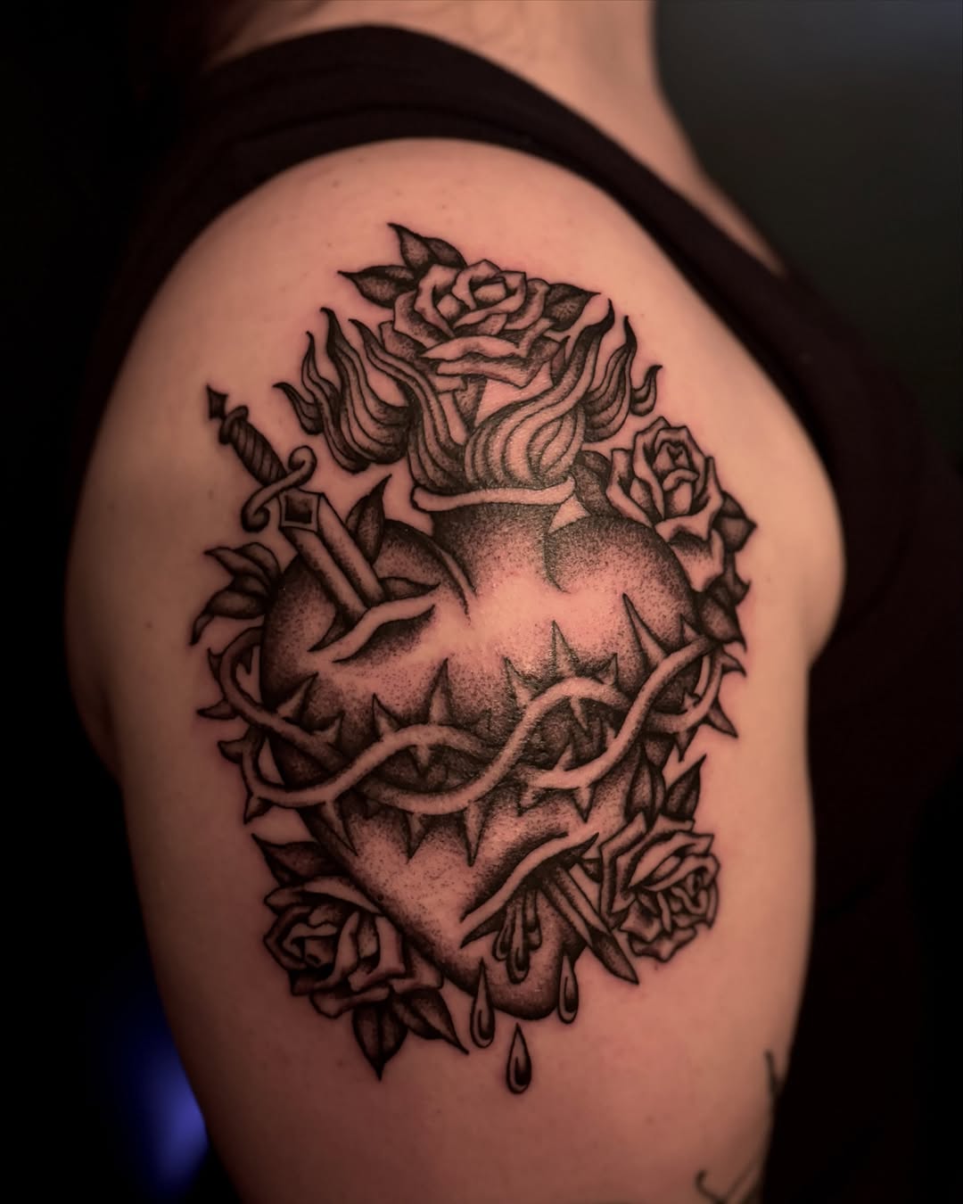 Heart with roses and thorns dotwork tattoo on the shoulder by Tia Cave