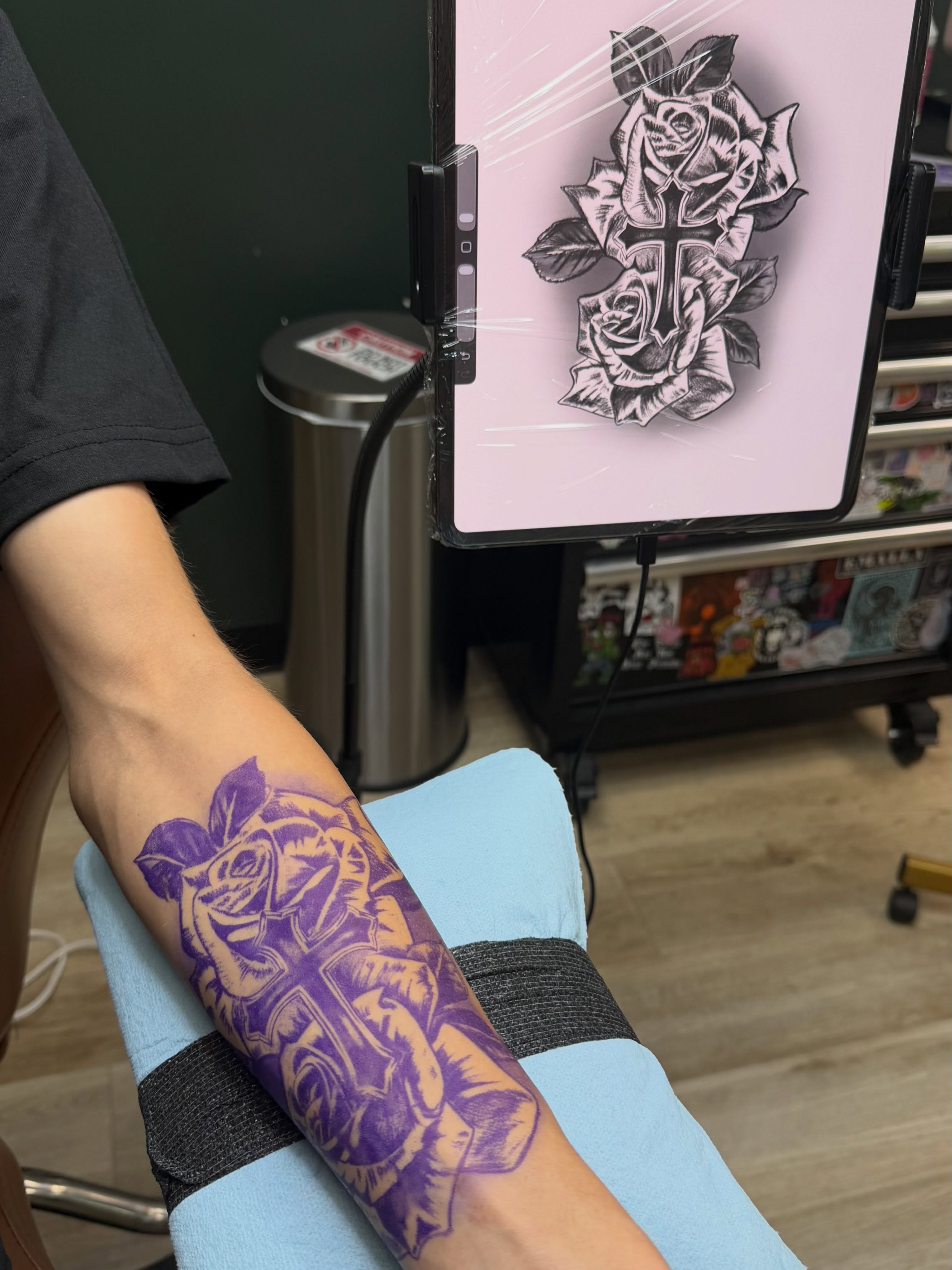 Rose and cross black and grey tattoo on the forearm by Bailee