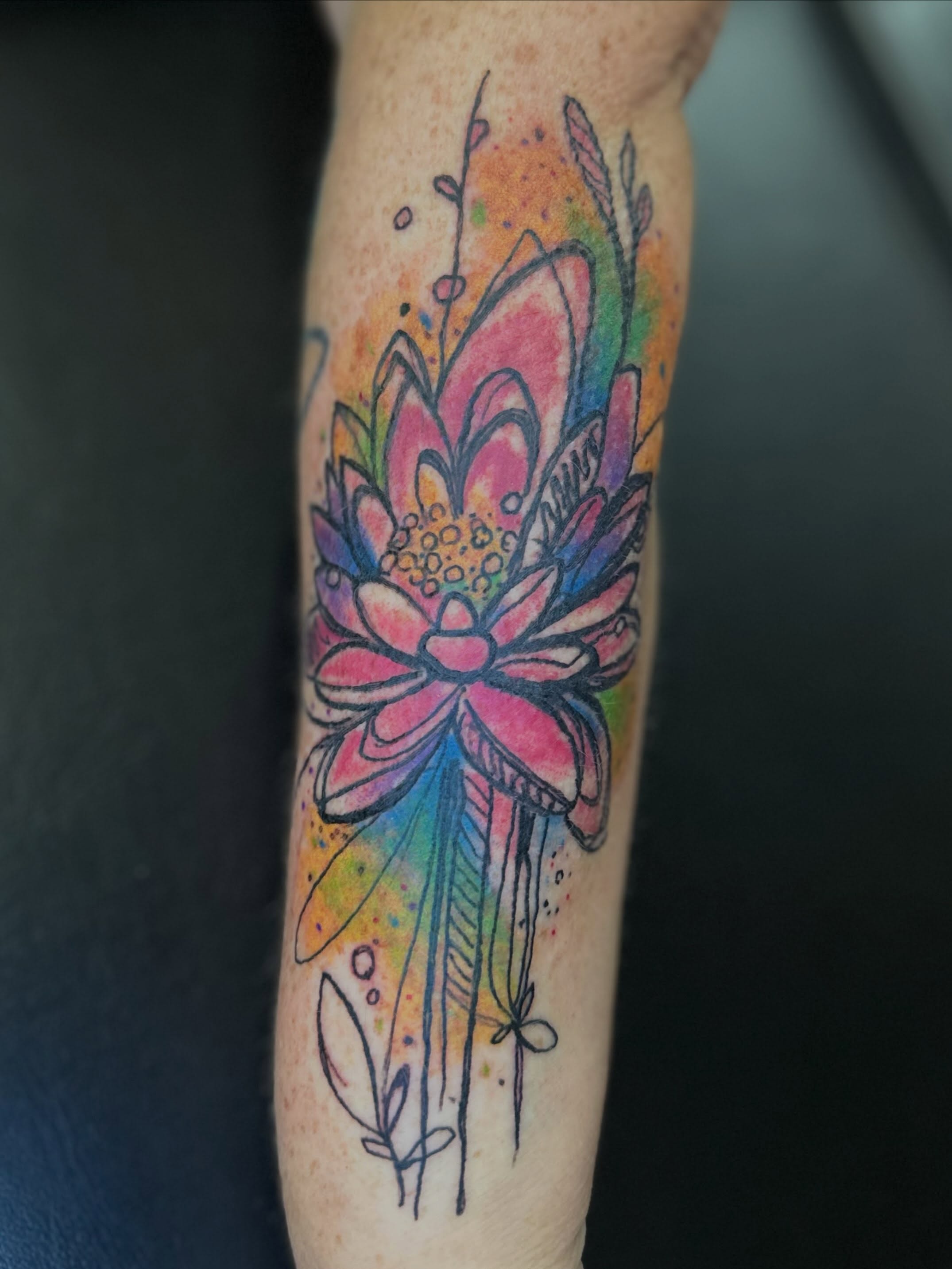 Lotus flower watercolor tattoo on the forearm by Zen Forbes